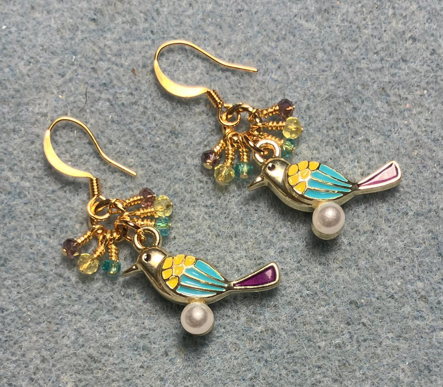 Yellow, turquoise, and violet enamel finch charm earrings adorned with tiny dangling yellow, turquoise, and violet Chinese crystal beads.