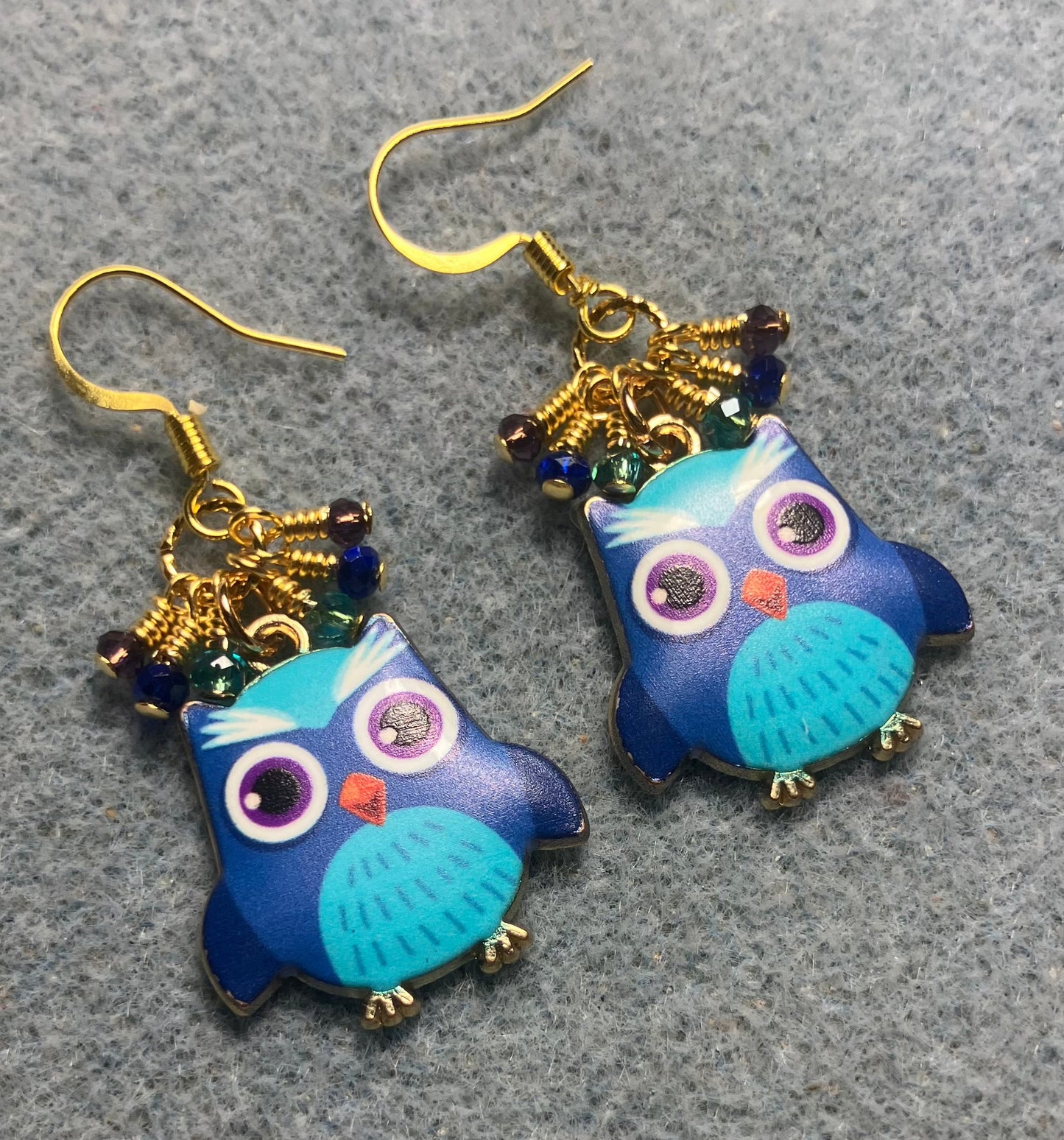 Dark blue, turquoise, and purple enamel owl charm earrings adorned with tiny dangling dark blue, turquoise, and purple Chinese crystal beads.