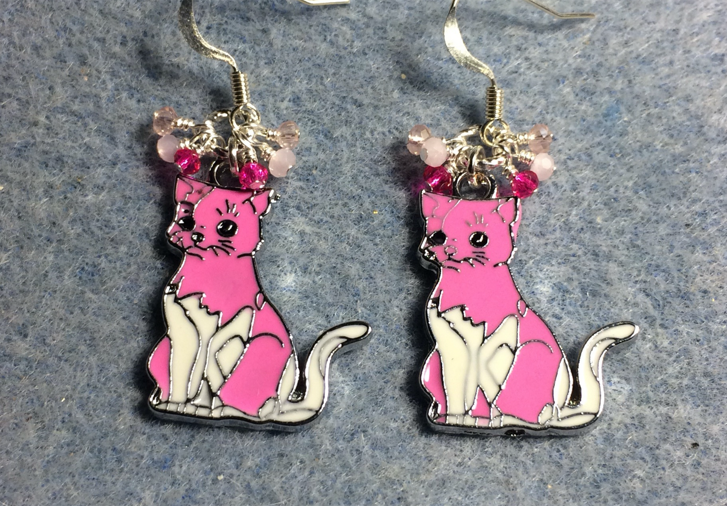 Pink and white enamel cat charm earrings adorned with tiny dangling pink and white Chinese crystal beads.