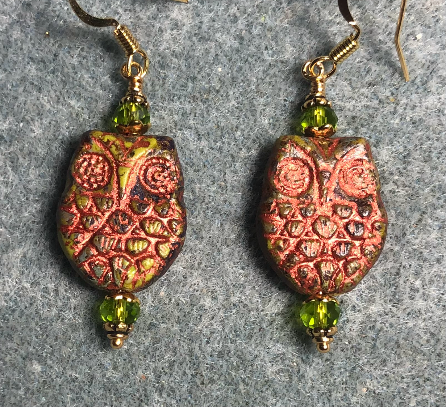 Olive green (with copper wash) Czech glass owl bead earrings adorned with olive green Chinese crystal beads.