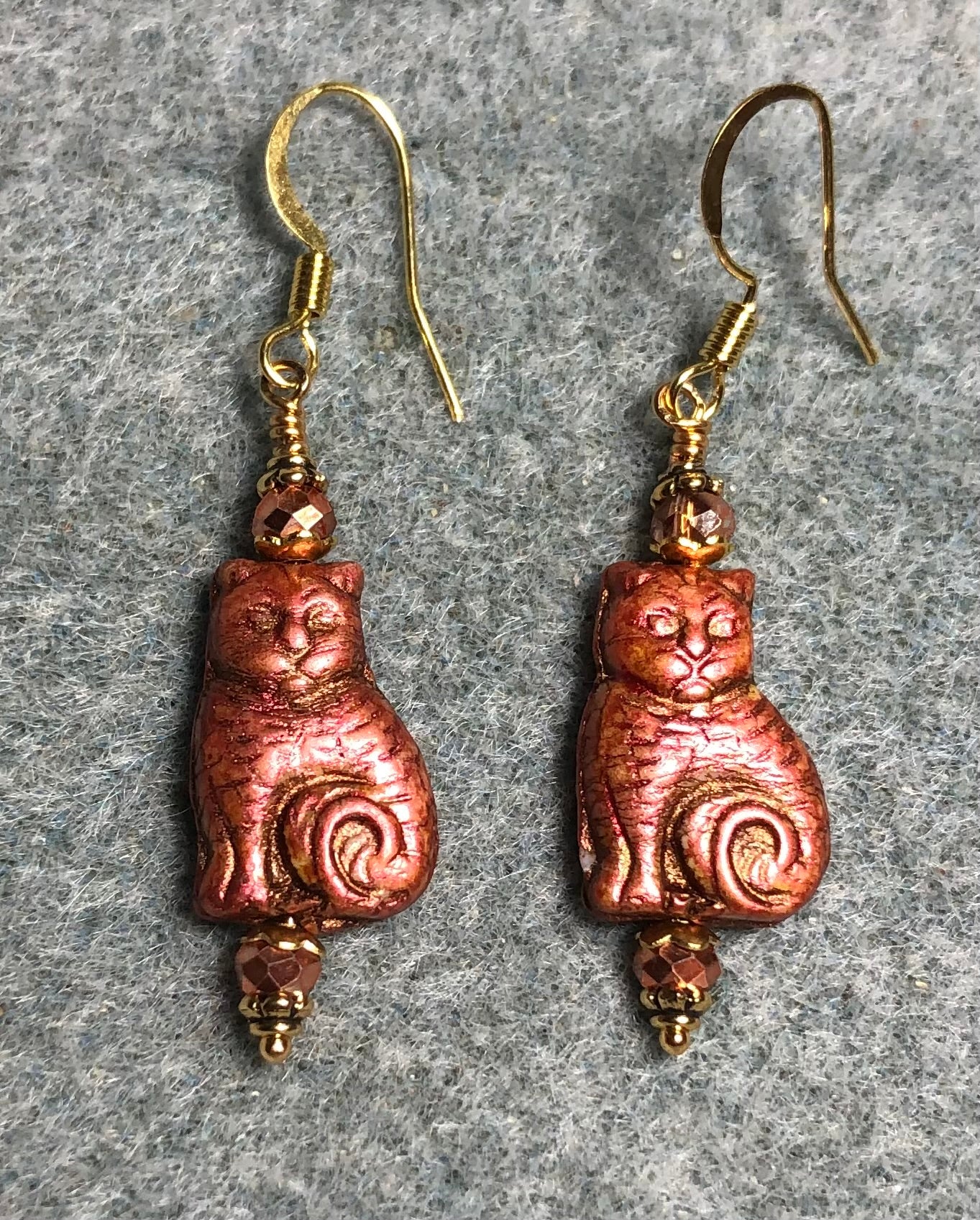 Medium metallic orange Czech glass cat bead earrings adorned with sparkly orange Chinese crystal beads.