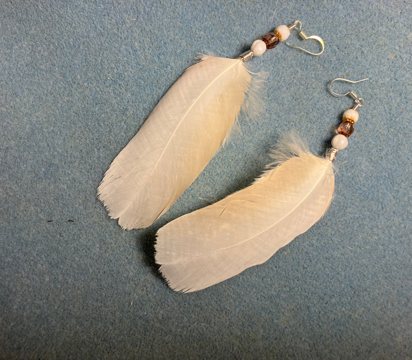 Whitish pink Moluccan cockatoo feather earrings adorned with white and pink Czech glass beads.
