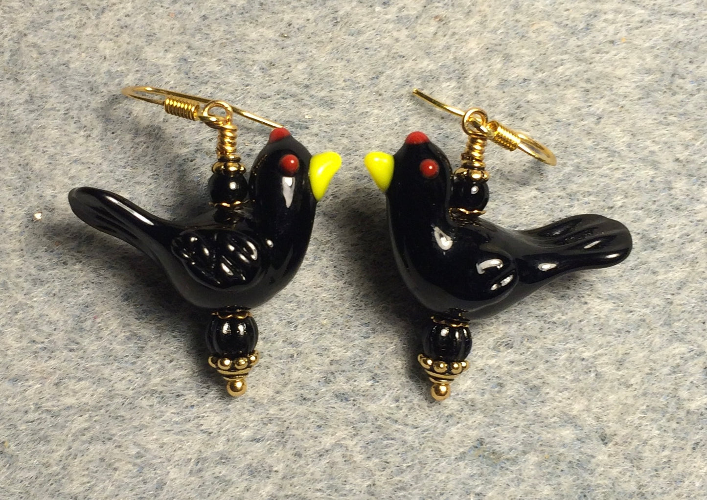 Opaque black lamp work songbird bead earrings adorned with black Czech glass beads.