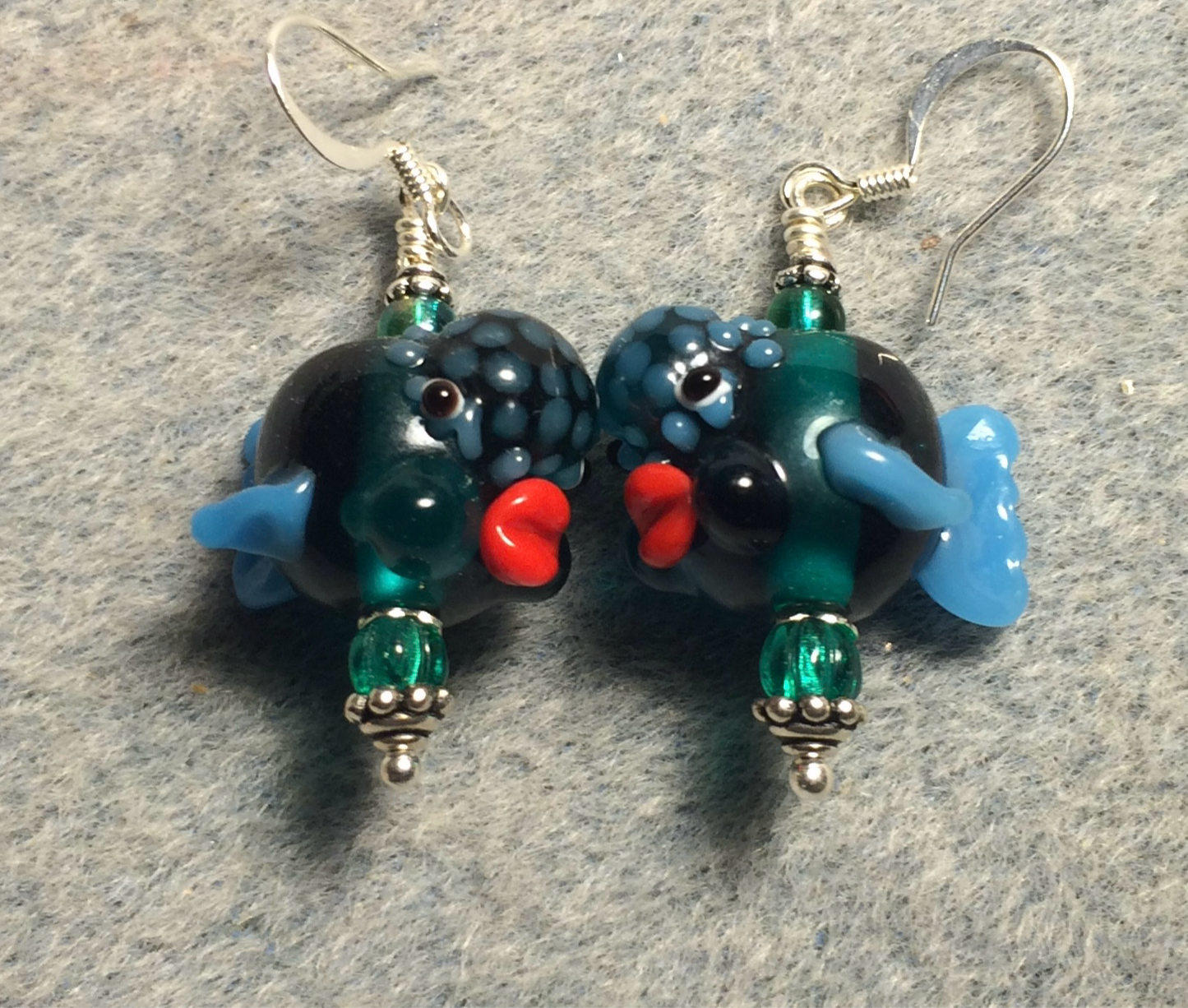 Translucent teal and blue lamp work clownfish bead earrings adorned with teal Czech glass beads.