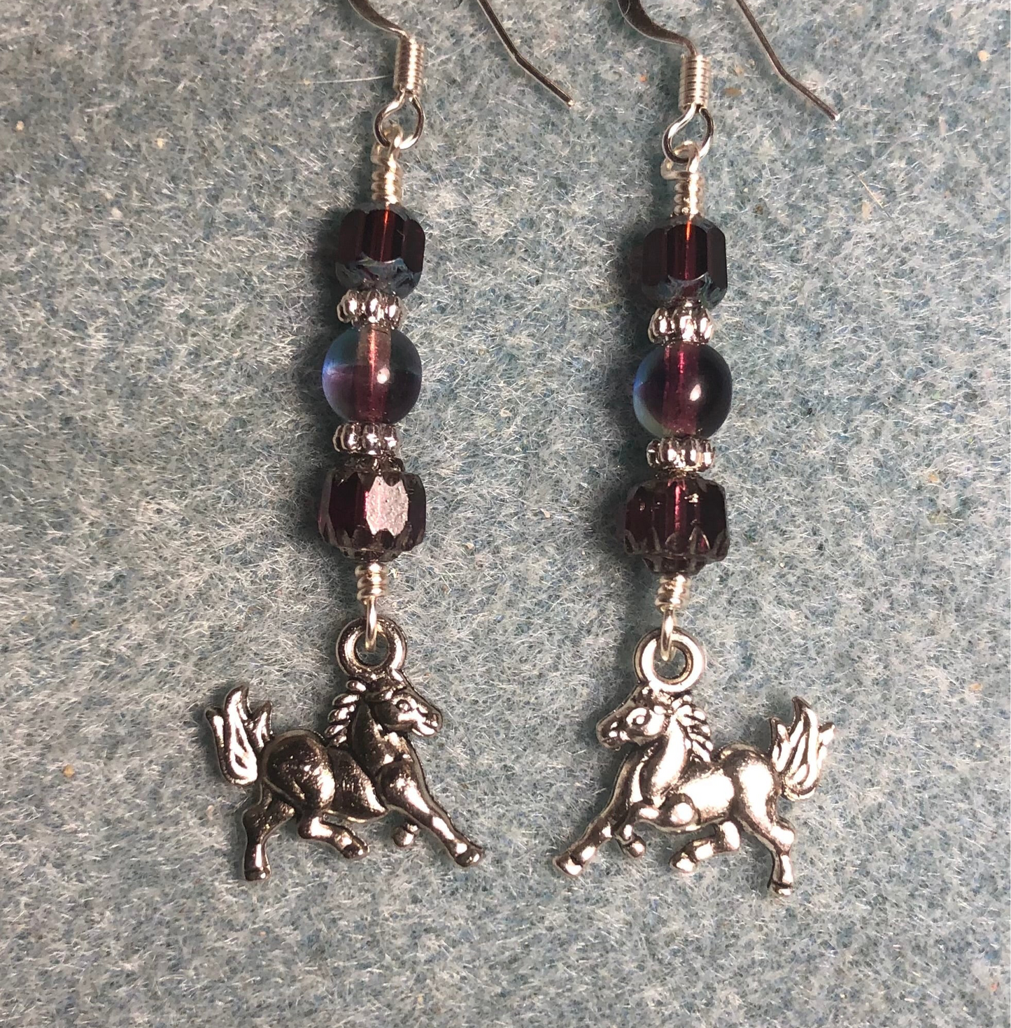 Silver horse charm earrings adorned with purple Czech glass beads