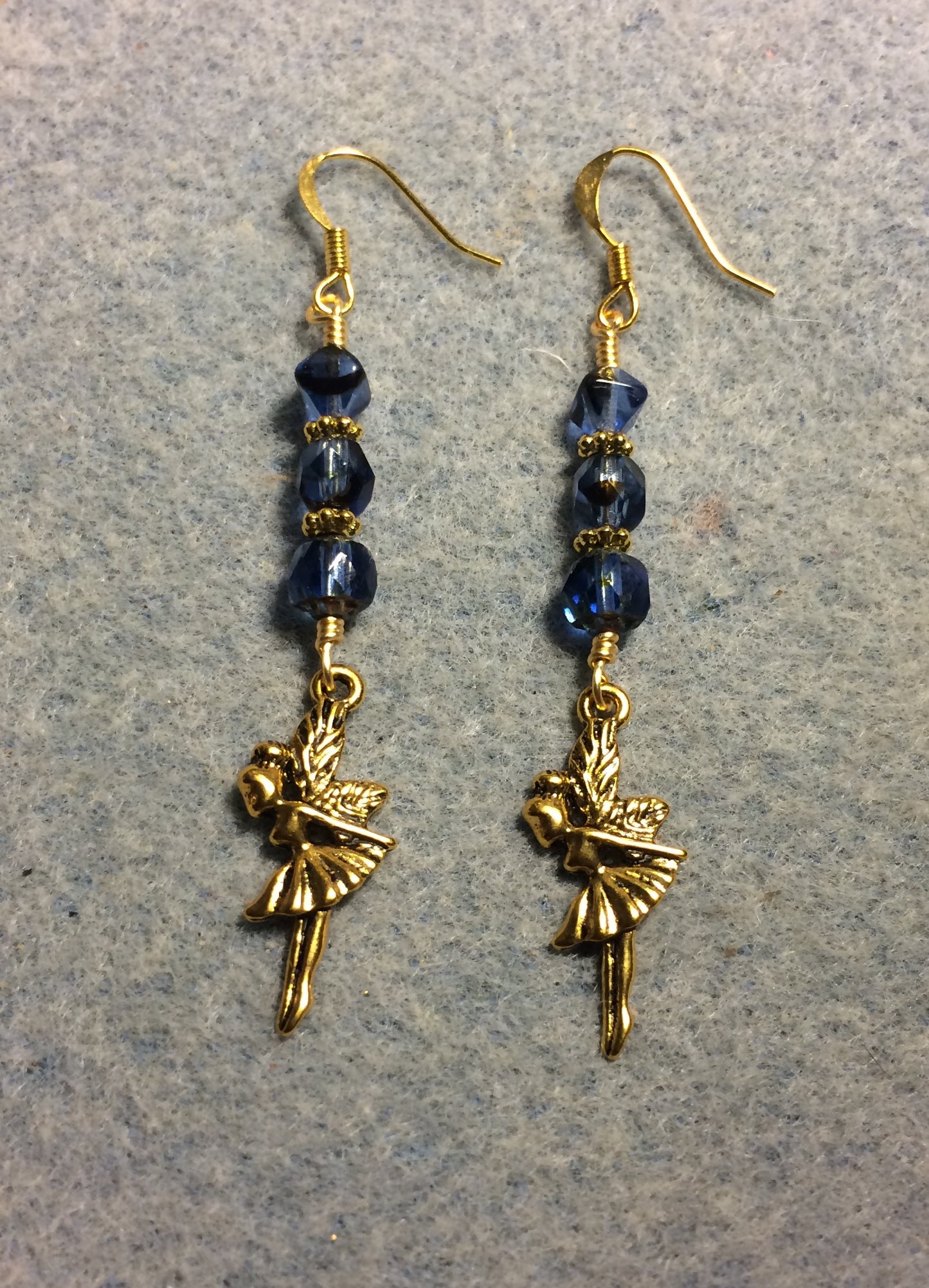 Gold fairy charm earrings adorned with blue Czech glass beads