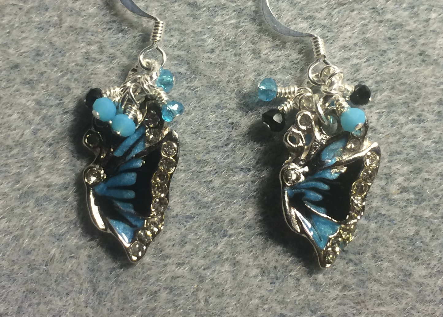Turquoise and black enamel butterfly charm earrings adorned with tiny dangling turquoise and black Chinese crystal beads.