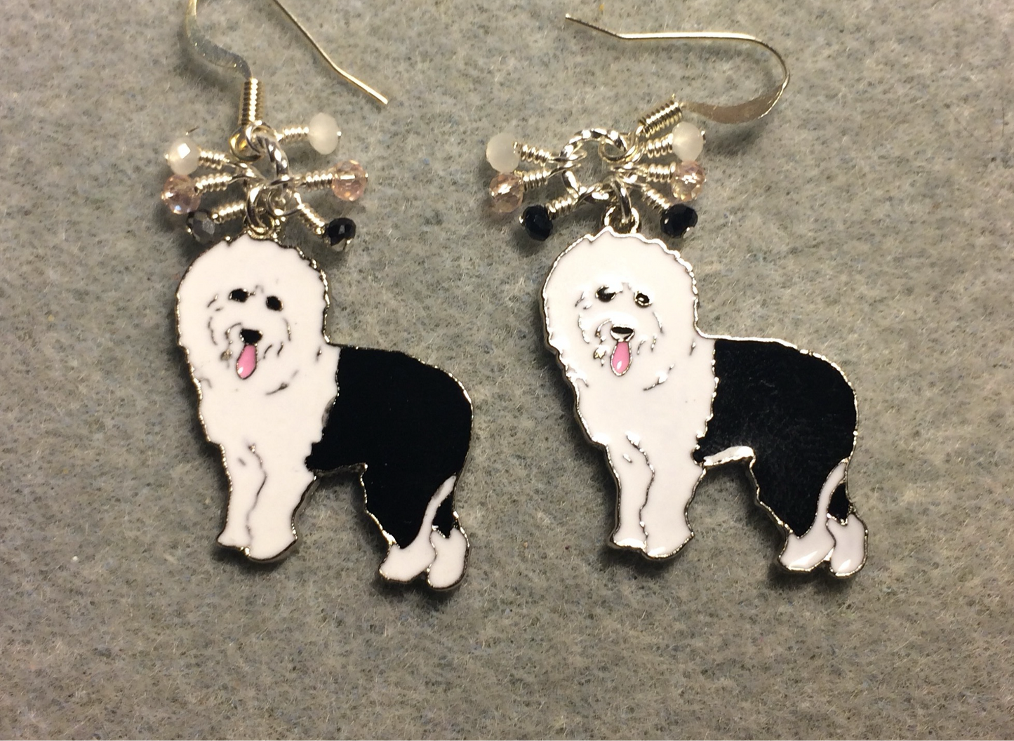 Black and white enamel sheepdog charm earrings adorned with tiny dangling black, white, and pink Chinese crystal beads.