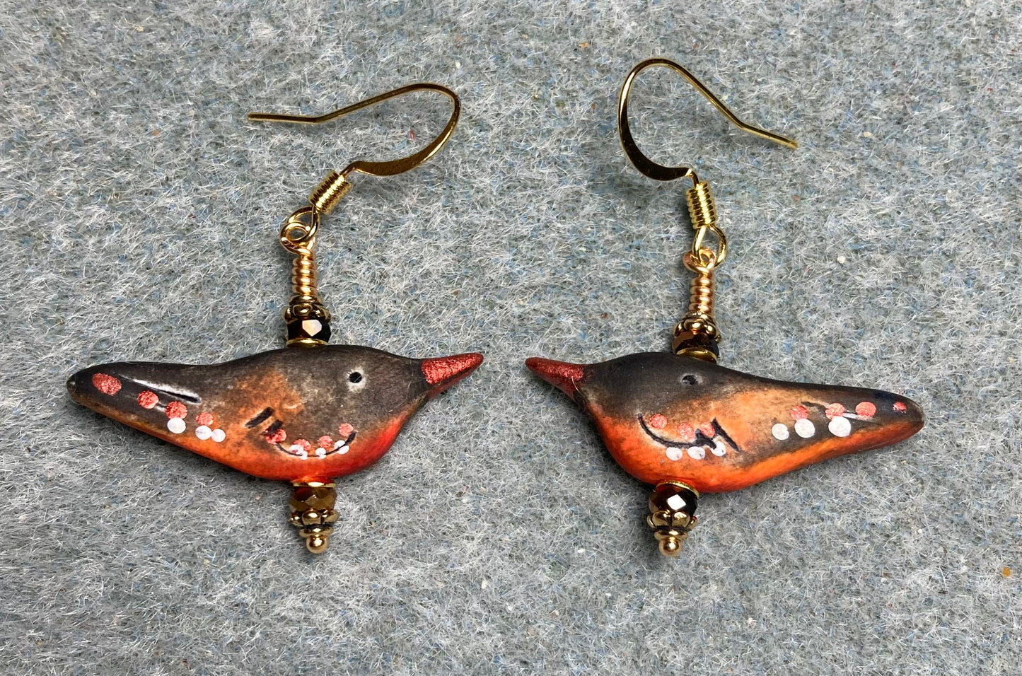 Small brown, black, and orange polymer clay bird bead earrings adorned with brown Chinese crystal beads.