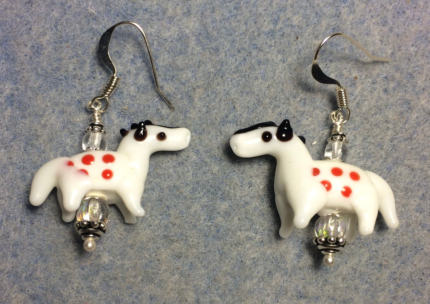 Opaque white and red lamp work spotted horse bead earrings adorned with clear Czech glass beads.