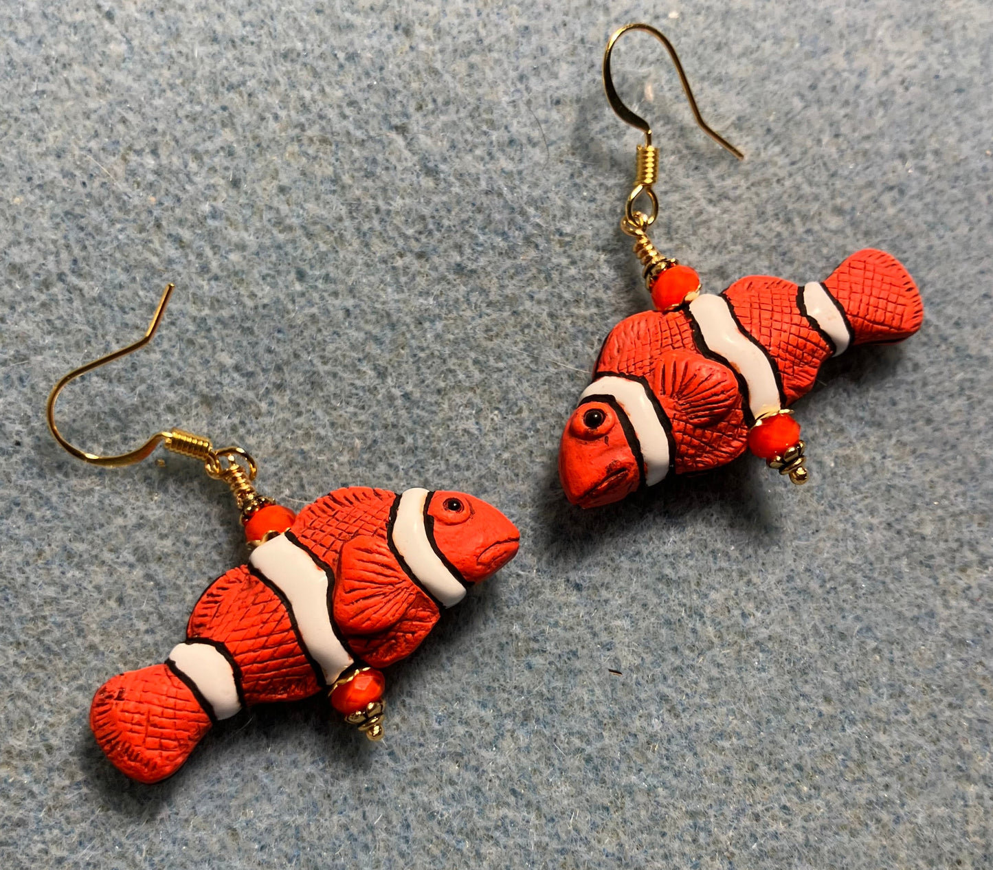Orange, black, and white ceramic striped clownfish bead earrings adorned with orange Chinese crystal beads.