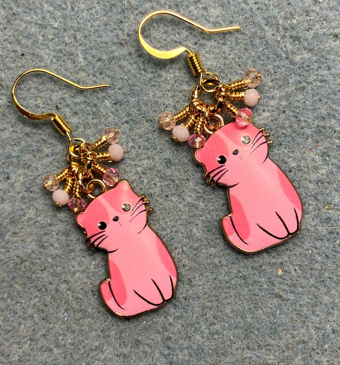 Pink enamel cat charm earrings adorned with tiny dangling pink Chinese crystal beads.