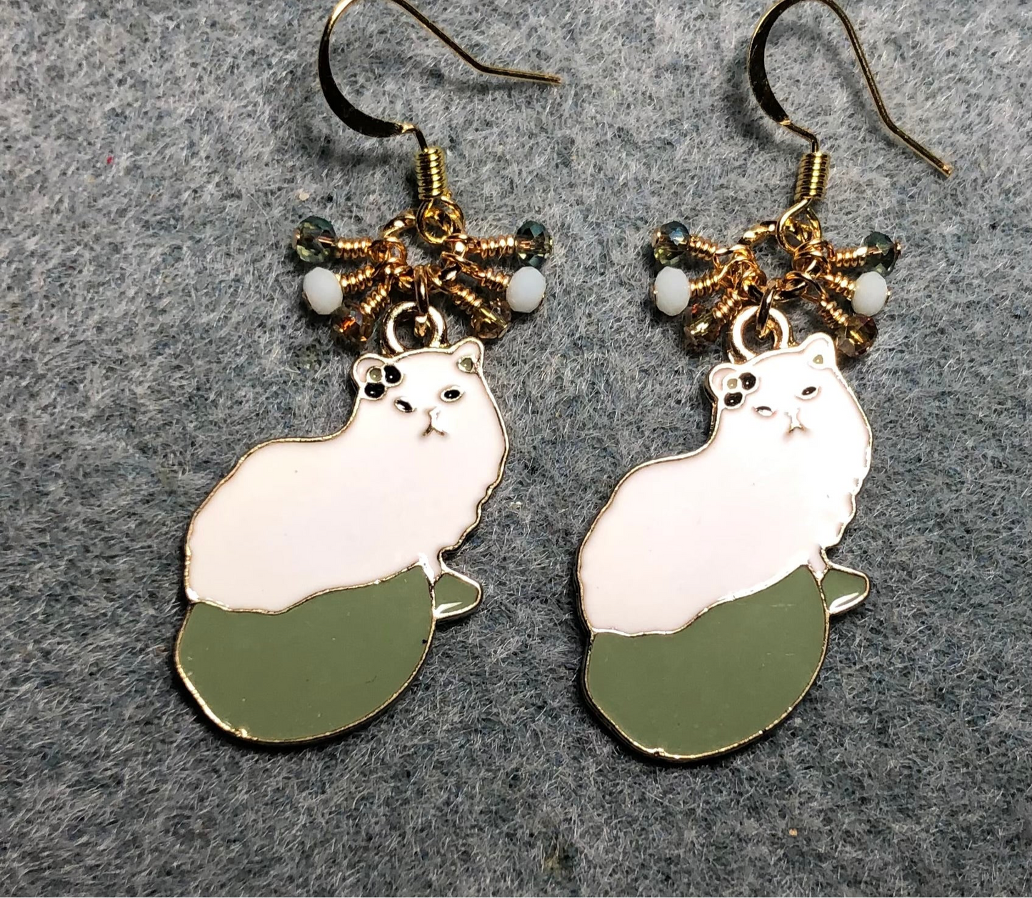 White and olive green enamel cat charm earrings adorned with tiny dangling white and olive green Chinese crystal beads.