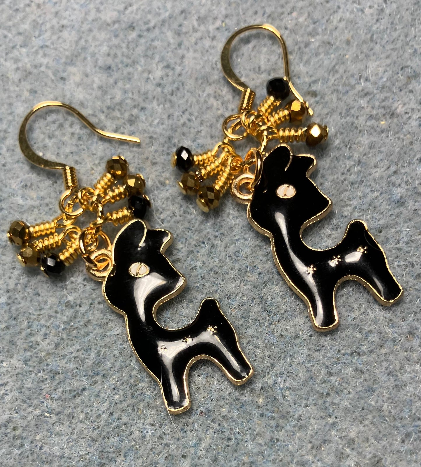 Black enamel deer charm earrings adorned with tiny dangling black and gold Chinese crystal beads.