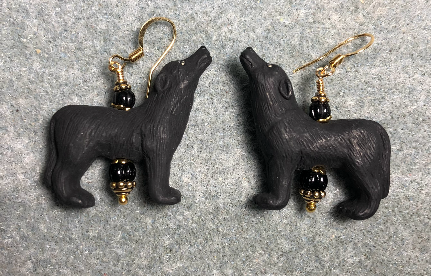 Black ceramic howling wolf bead earrings adorned with black Czech glass beads.