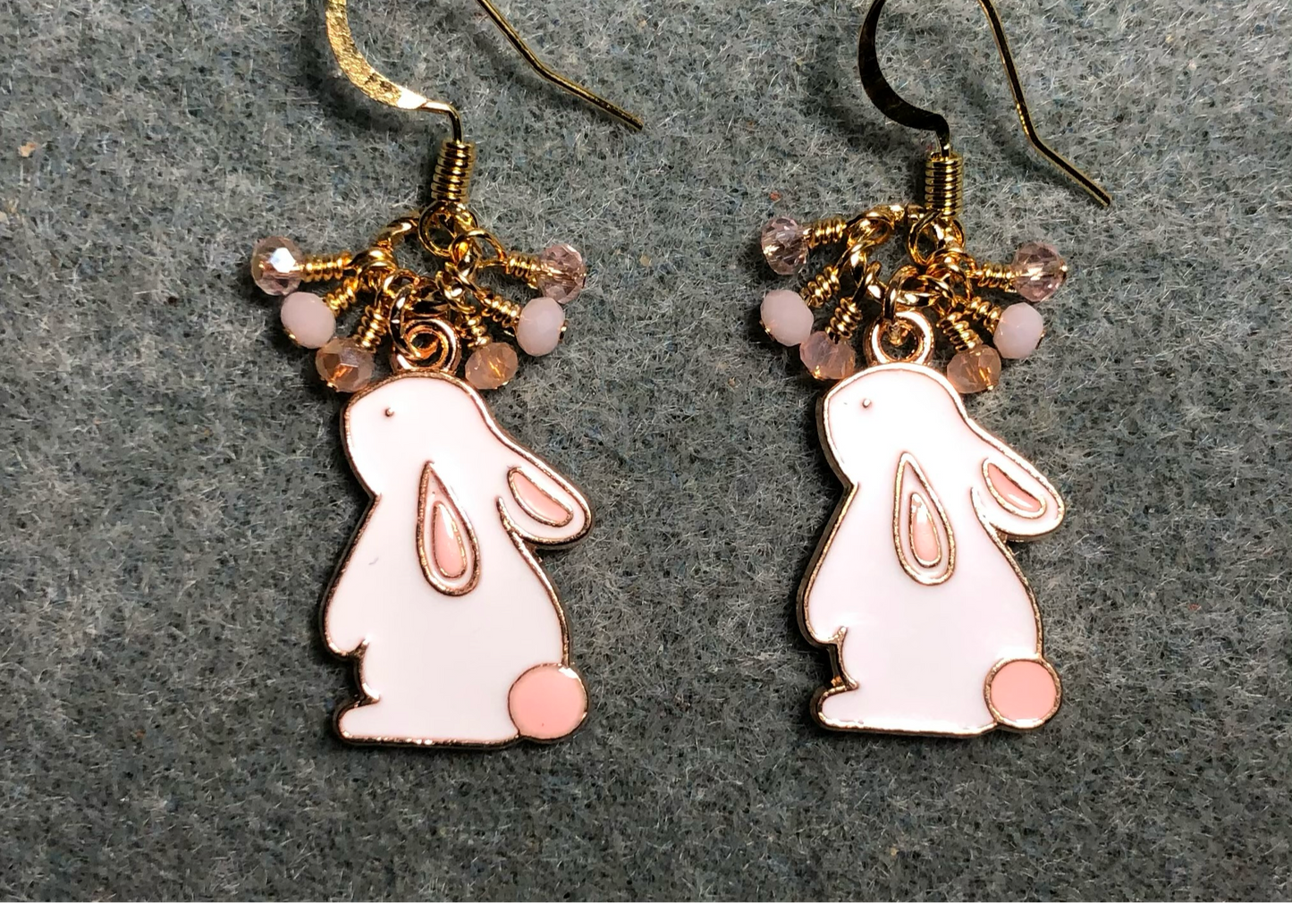 Pink and white enamel rabbit charm earrings adorned with pink and peach Chinese crystal beads.