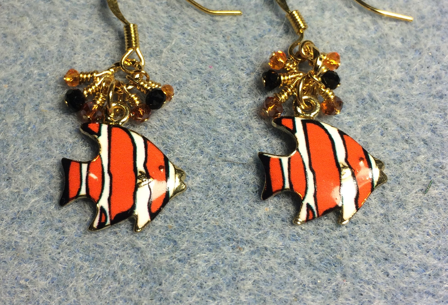 Orange, black, and white enamel striped angelfish charm earrings adorned with tiny dangling orange, black, and white Chinese crystal beads.