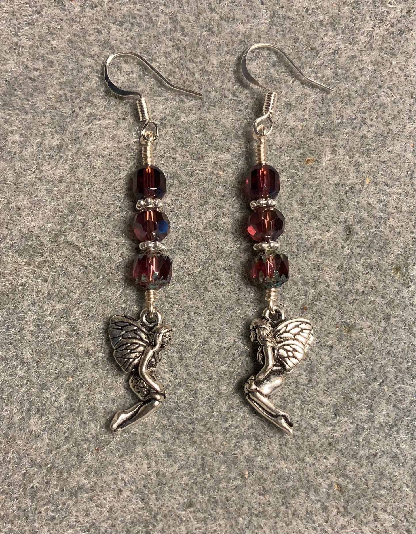 Silver Tierracast fairy charm earrings adorned with purple Czech glass beads.