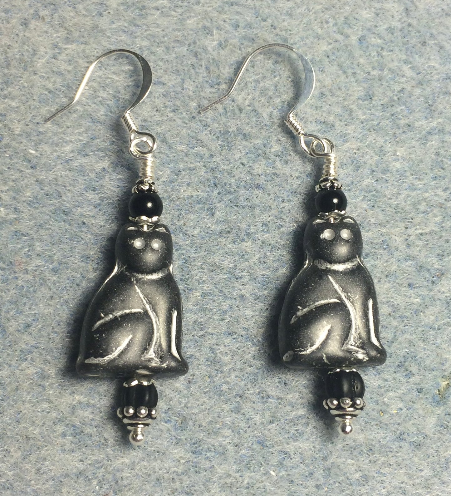 Matte black (with white inlay) Czech glass cat bead earrings adorned with black Czech glass beads.