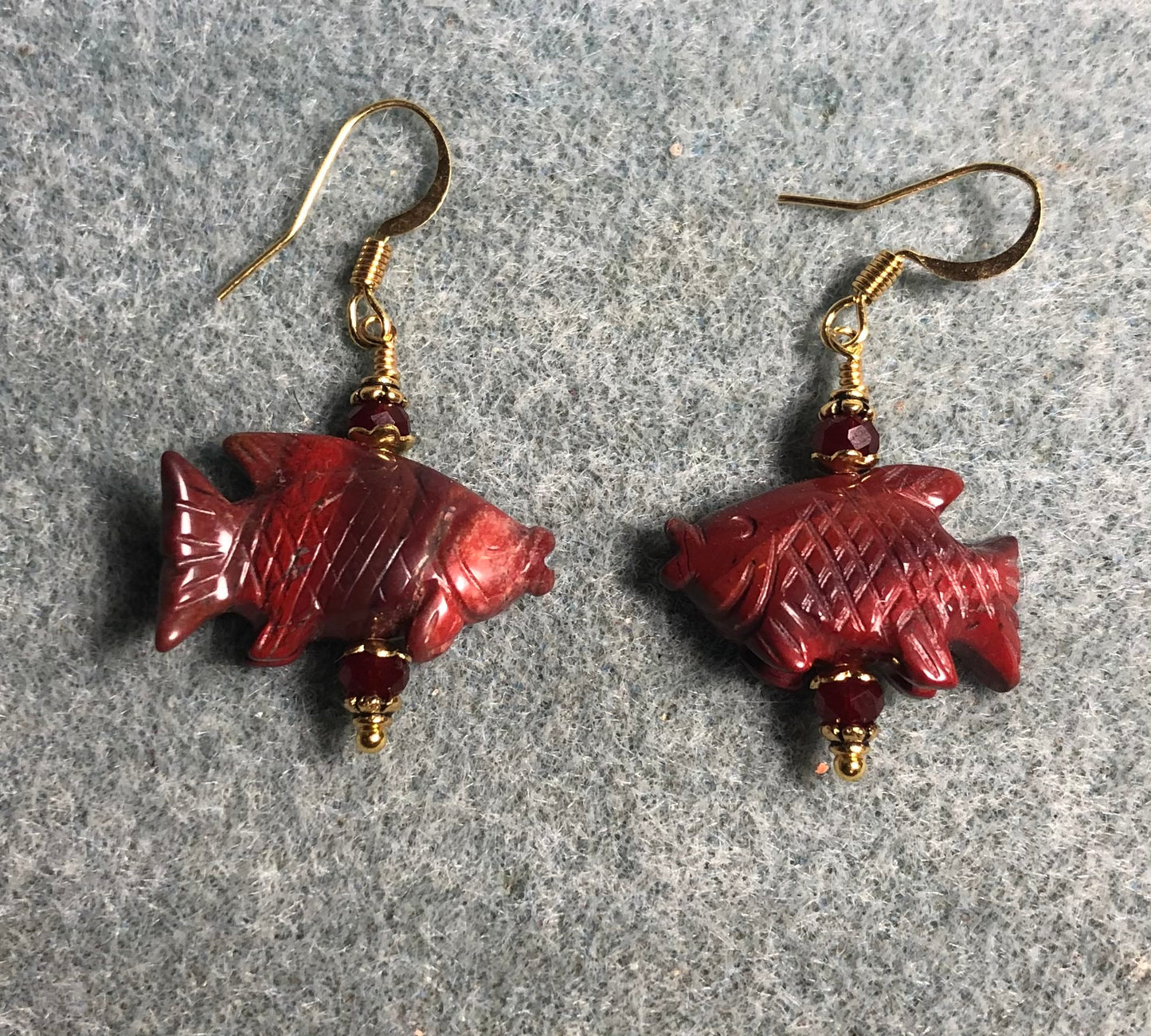 Red poppy jasper gemstone fish bead earrings adorned with dark red Chinese crystal beads.