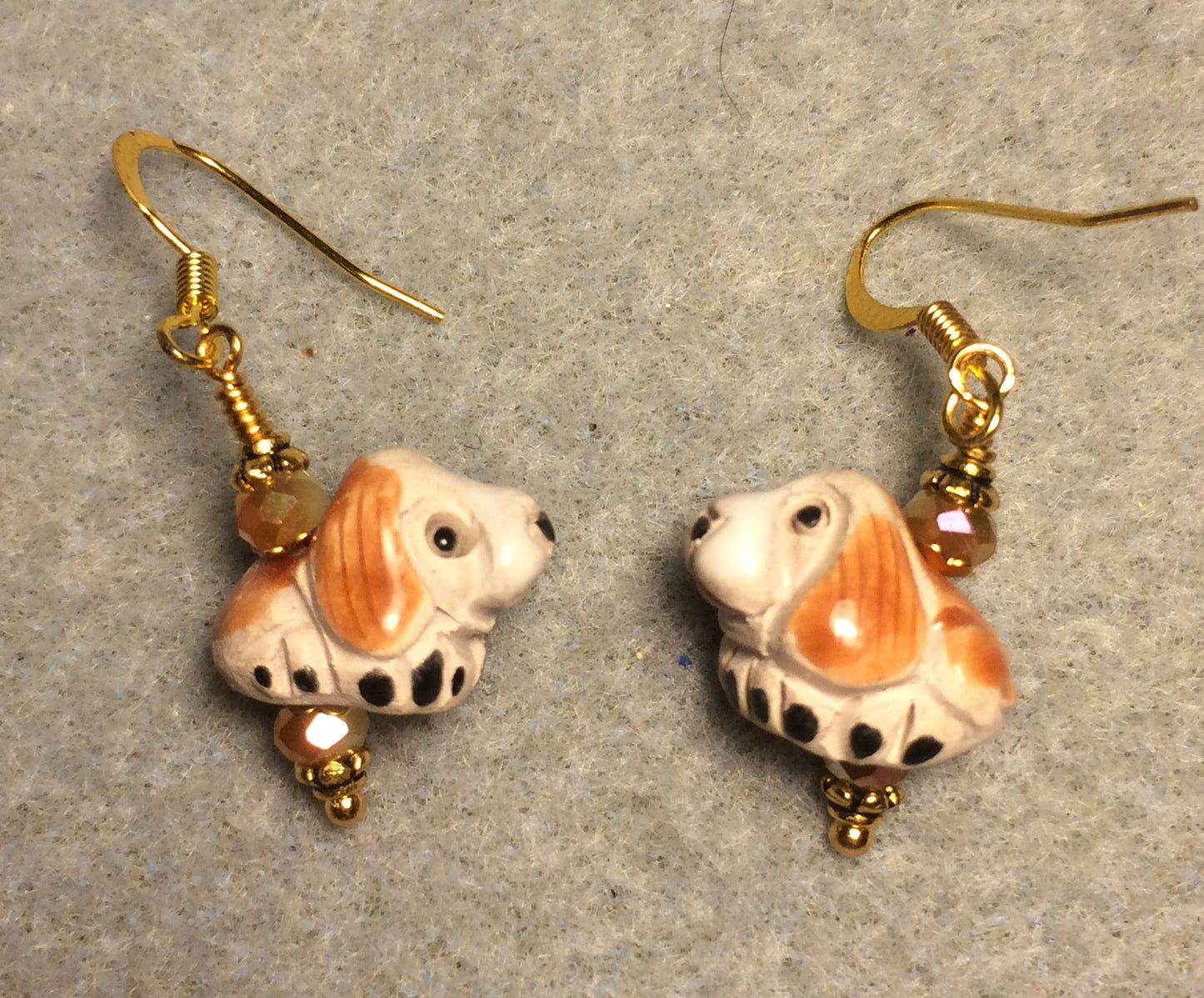 Small tan and beige ceramic hound dog bead earrings adorned with tan Chinese crystal beads.