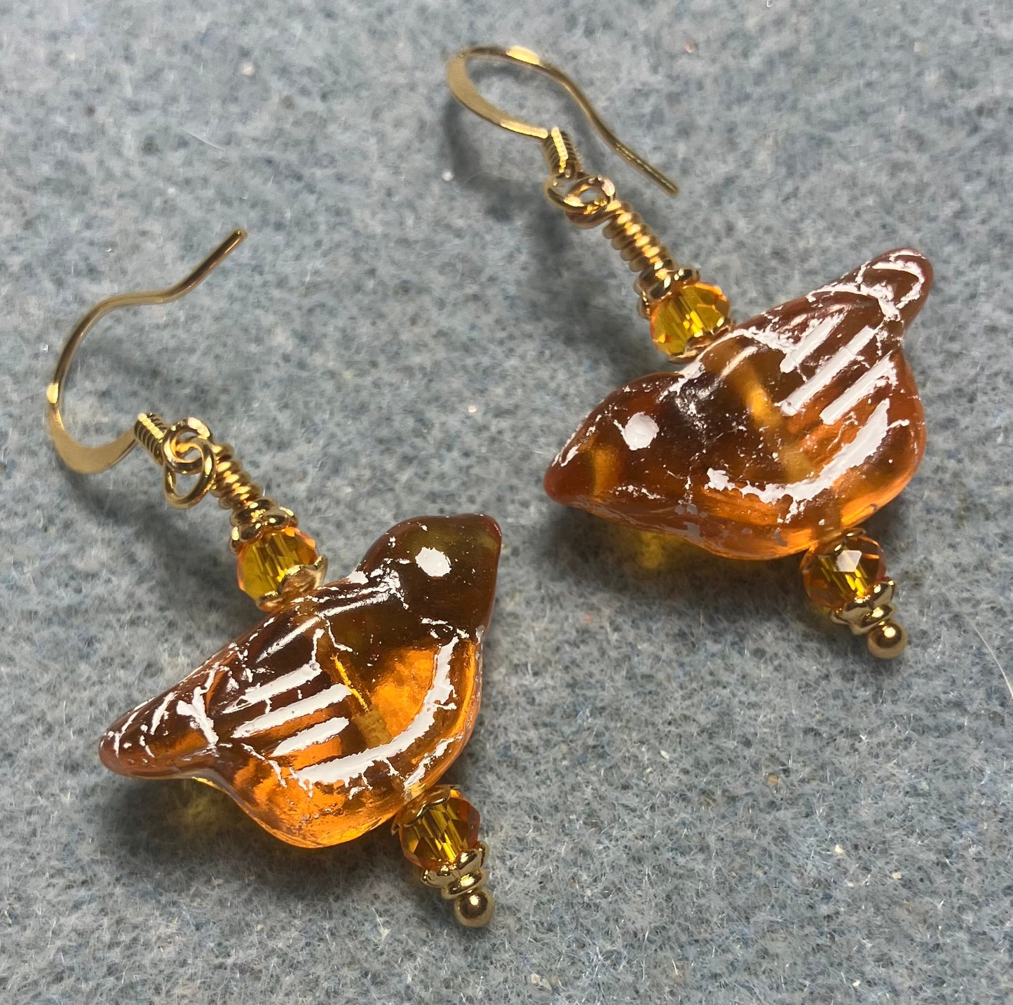 Amber (with white inlay) Czech glass bird bead earrings adorned with amber Chinese crystal beads.