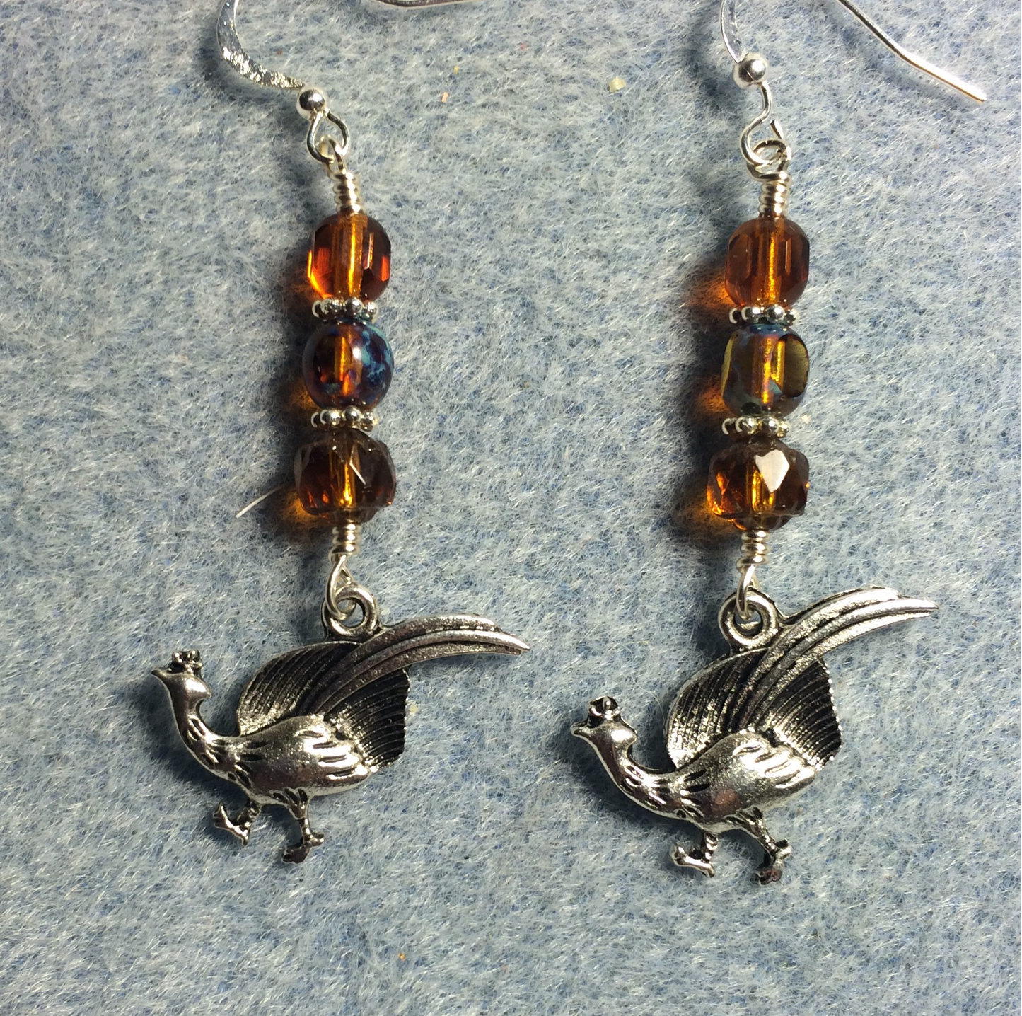 Silver pheasant charm earrings adorned with amber Czech glass beads