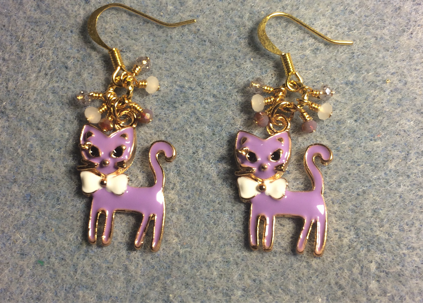 Violet and white enamel and rhinestone cat charm earrings adorned with small dangling violet and white Chinese crystal beads.