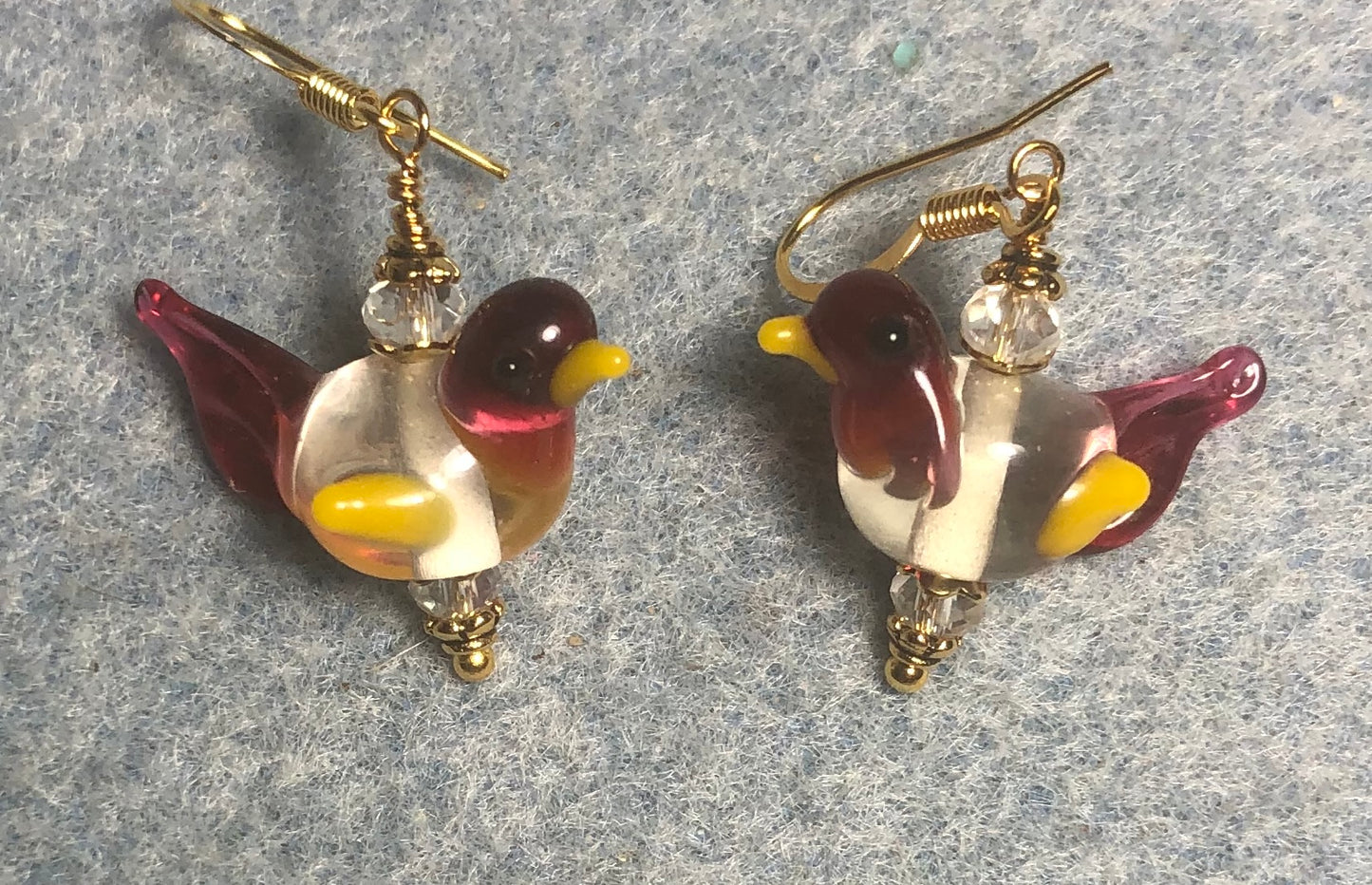 Pink, yellow, and clear lamp work songbird bead earrings adorned with clear Chinese crystal beads.