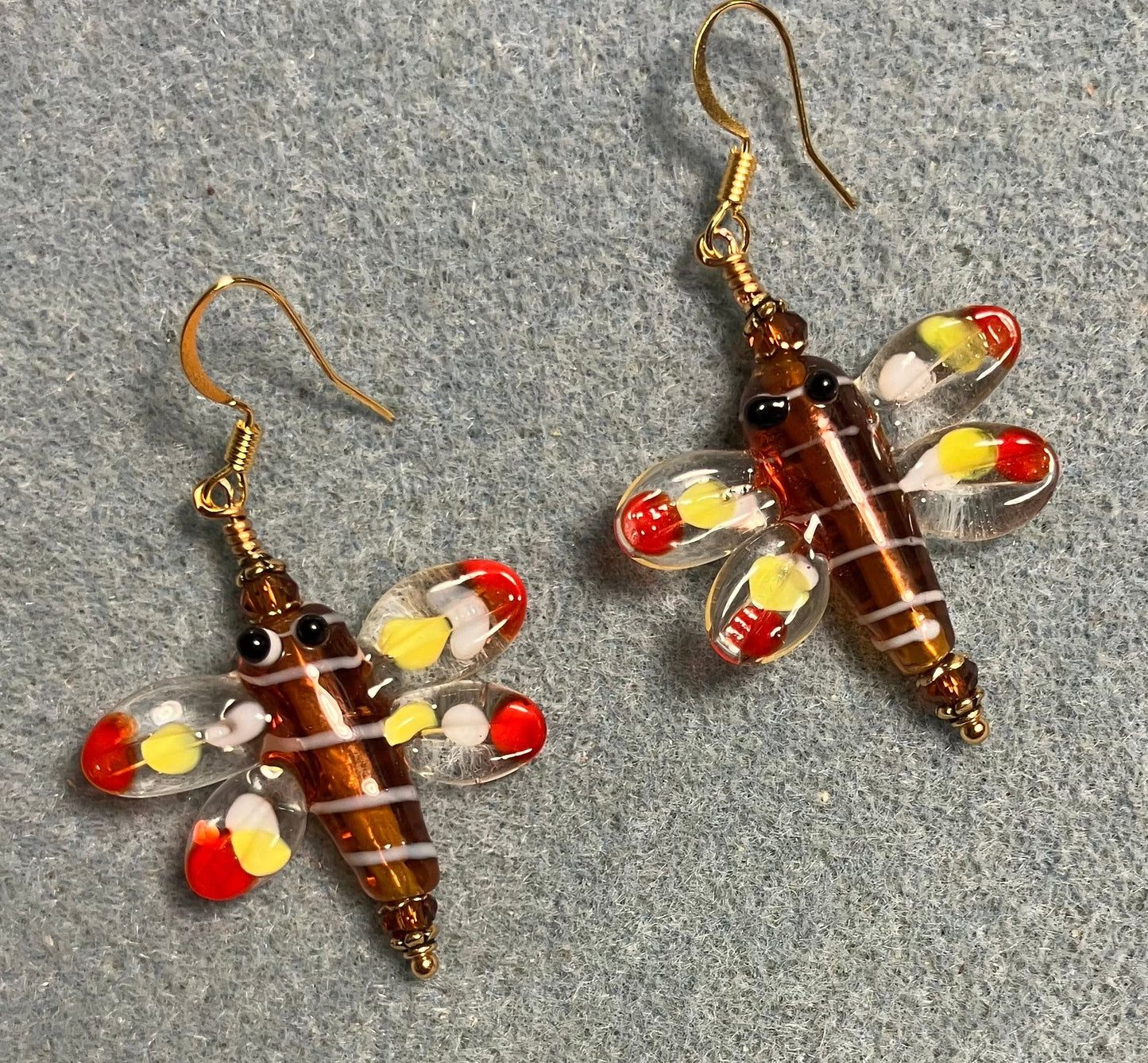 Brown, red, and yellow lamp work dragonfly bead earrings adorned with brown Chinese crystal beads.