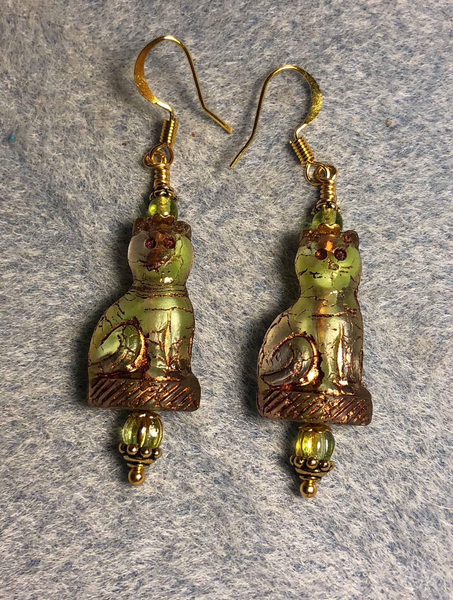 Green and clear (with gold inlay) fancy Czech glass cat bead earrings adorned with green Czech glass beads.