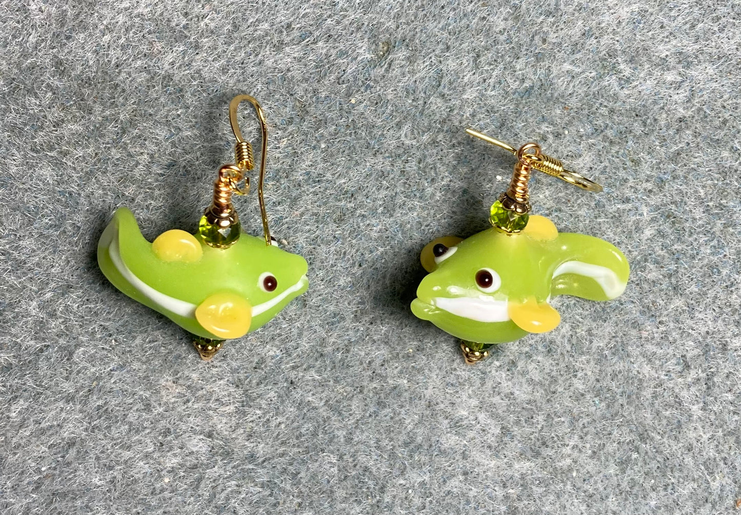 Lime green and yellow lamp work fish bead earrings adorned with lime green Chinese crystal beads.