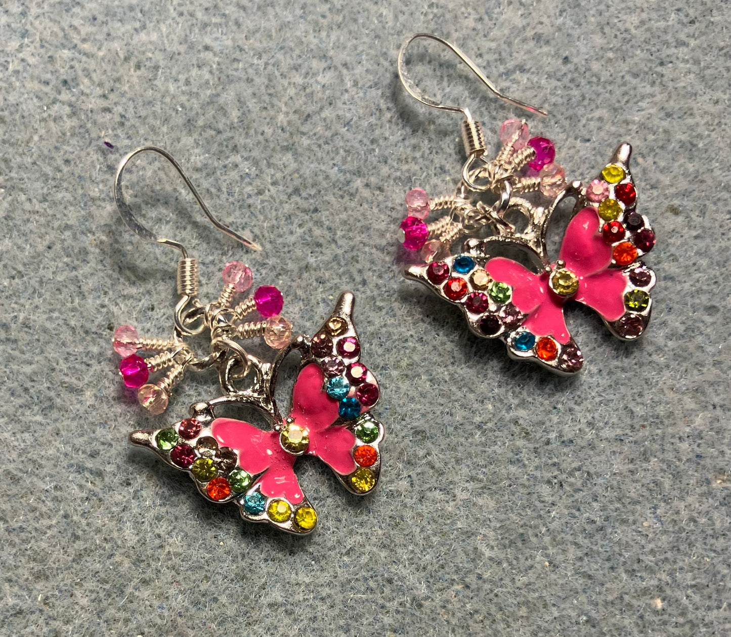 Hot pink enamel and colored rhinestone butterfly charm earrings adorned with tiny dangling hot pink and light pink Chinese crystal beads.