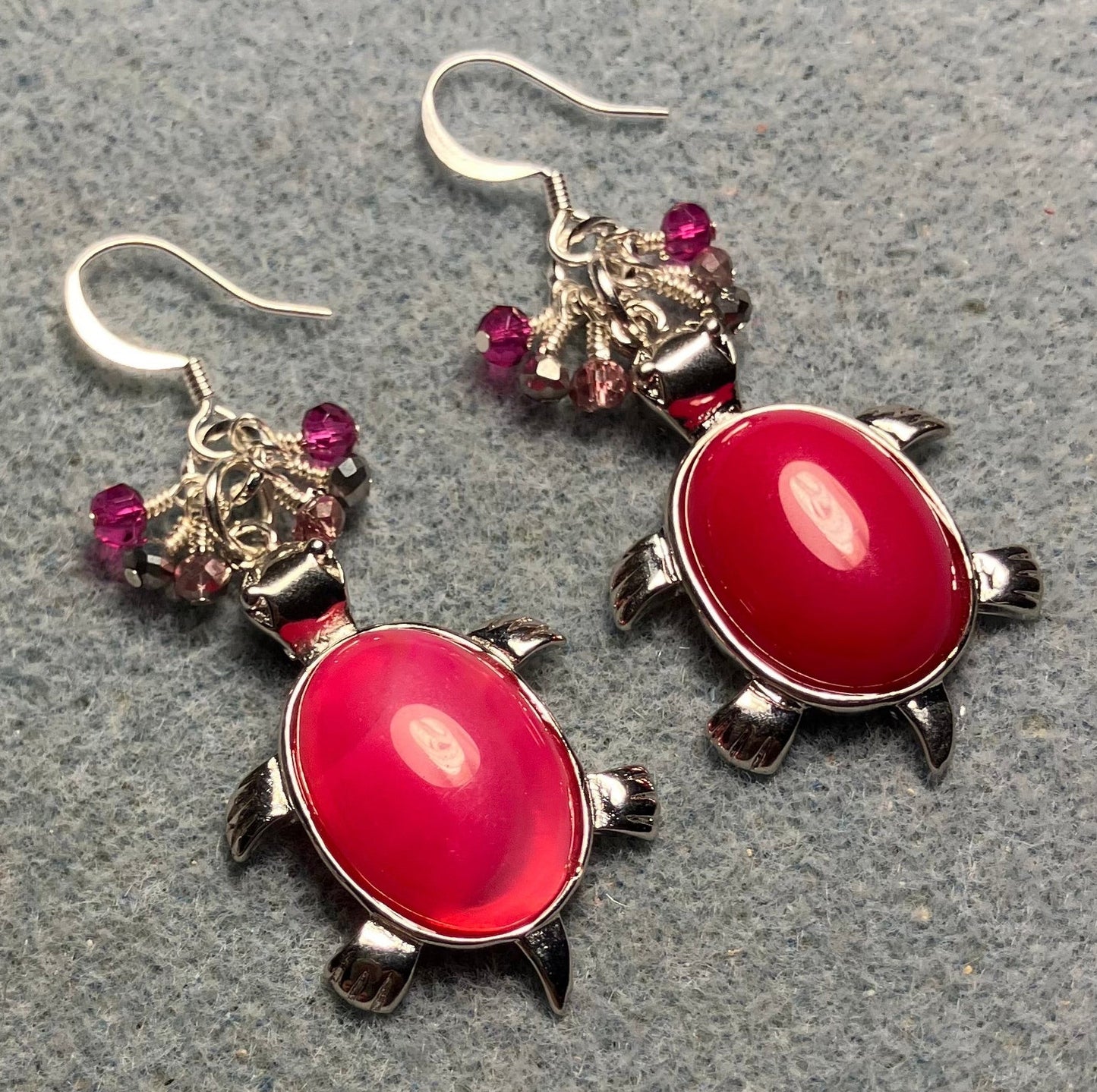 Large silver and hot pink agate gemstone turtle charm earrings adorned with small dangling hot pink, pink, and silver Chinese crystal beads.