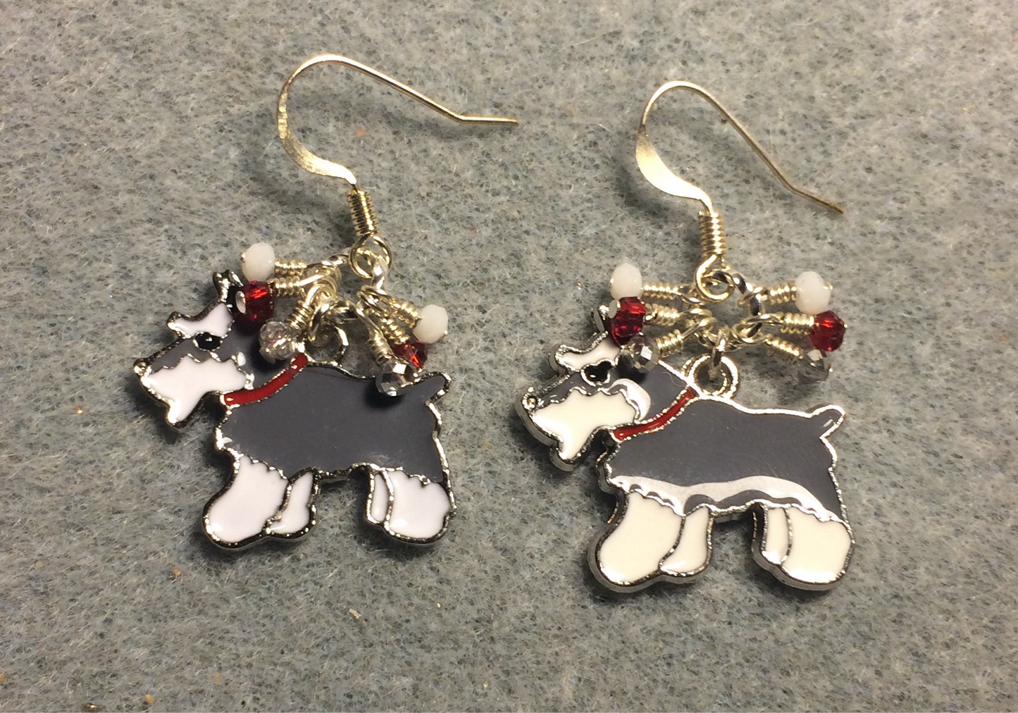 Gray and white enamel Schnauzer dog charm earrings adorned with tiny dangling white, silver, and red Chinese crystal beads.