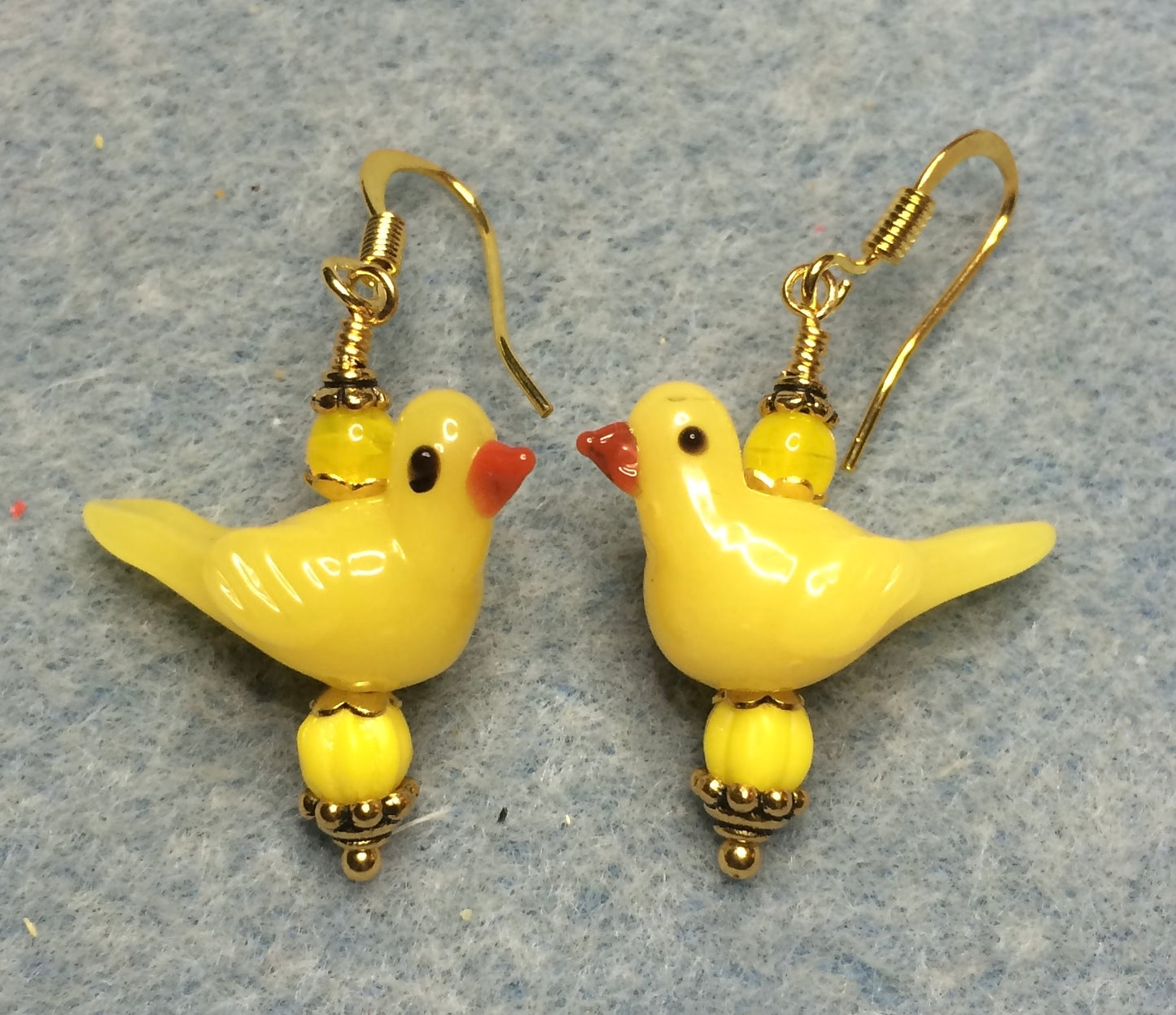 Opaque yellow lamp work songbird bead earrings adorned with yellow Czech glass beads.