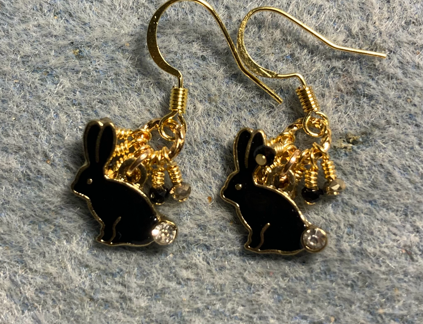 Small black enamel and rhinestone rabbit charm earrings adorned with black and gold Chinese crystal beads.