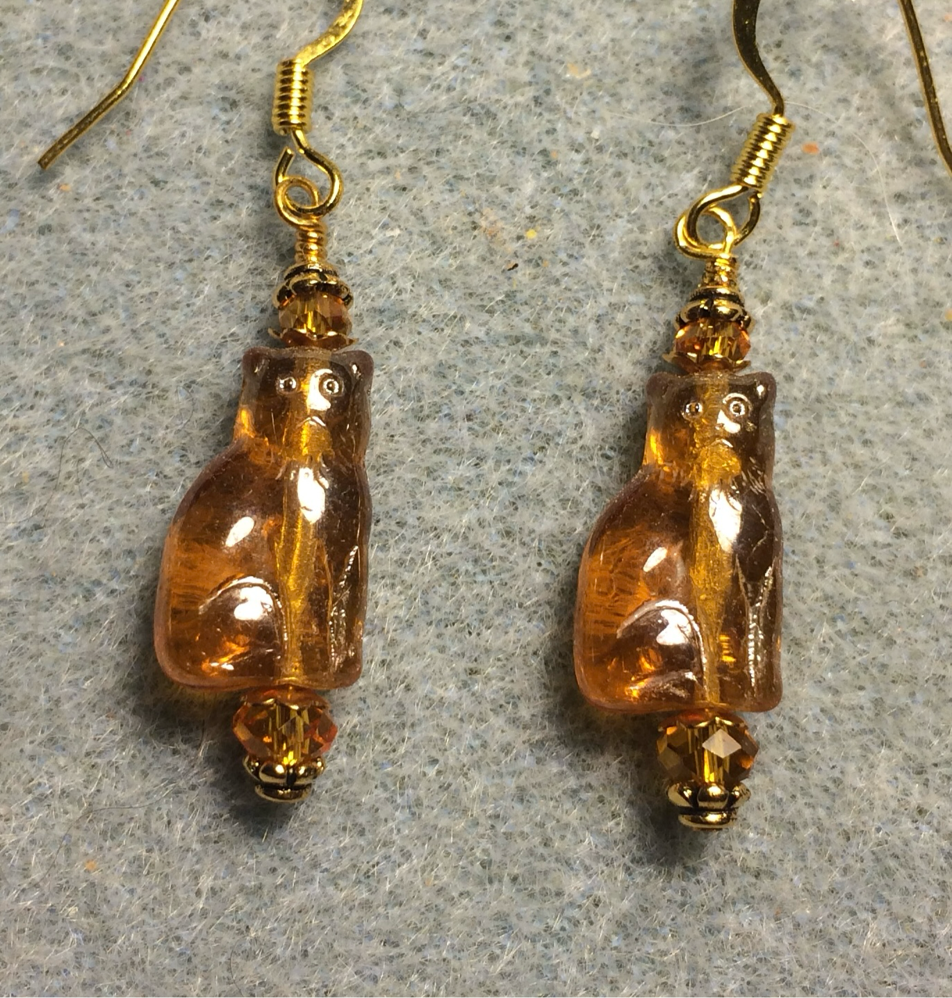 Small translucent amber Czech glass cat bead earrings adorned with amber Chinese crystal beads.