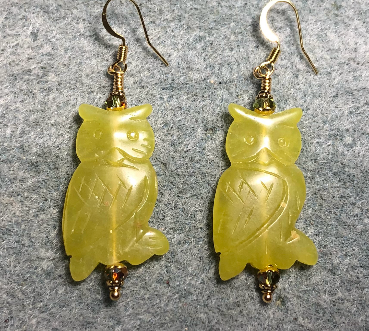 Large green serpentine gemstone owl bead earrings adorned with sparkly olive green Chinese crystal beads.