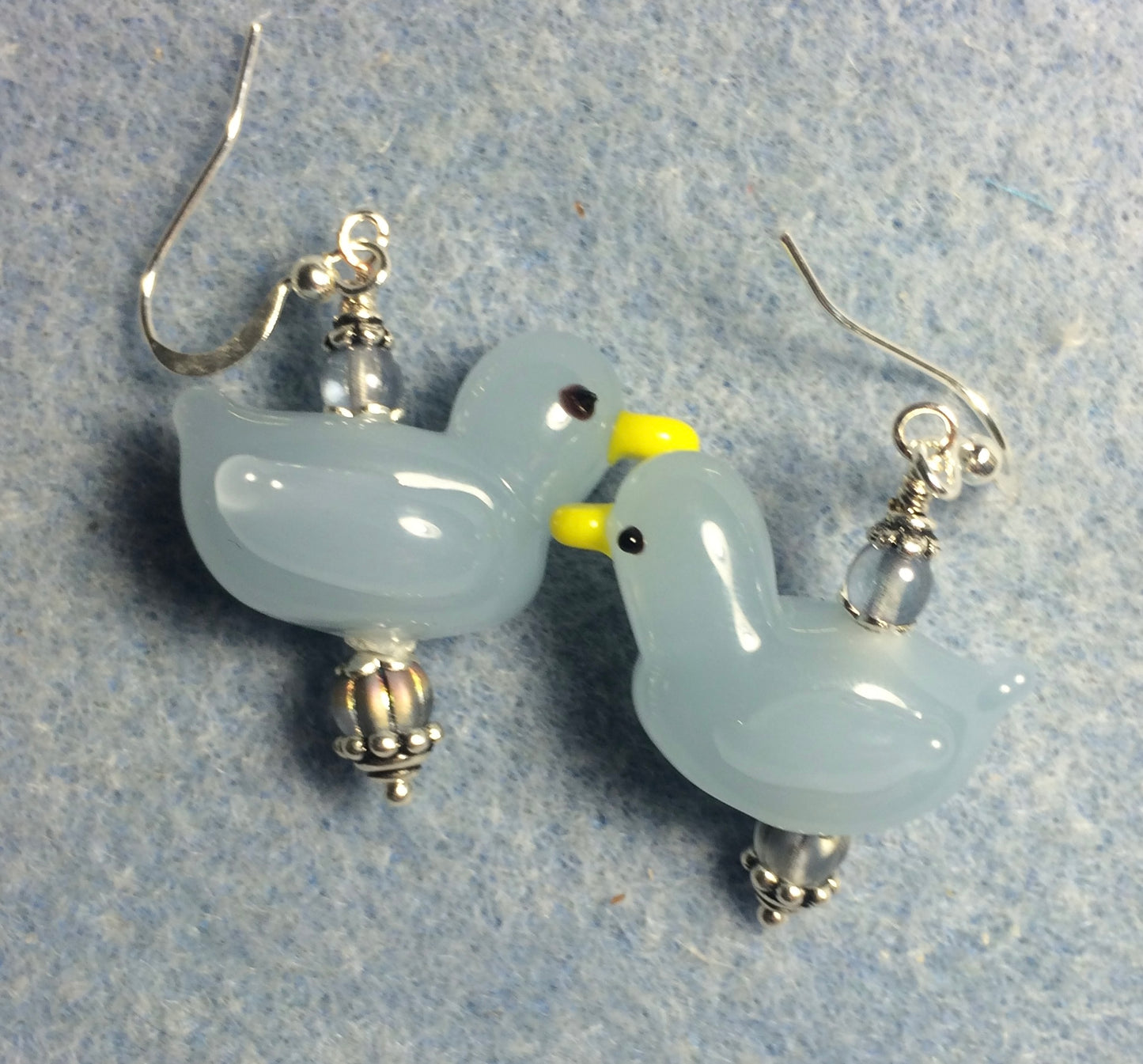 Light blue lamp work duck bead earrings adorned with light blue Czech glass beads.
