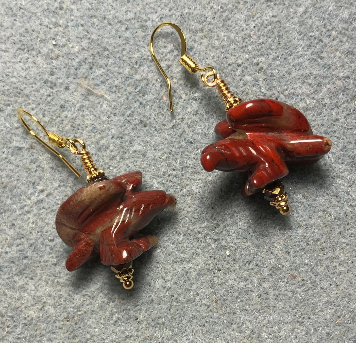 Large red poppy jasper gemstone flying eagle bead earrings adorned with dark red Chinese crystal beads.