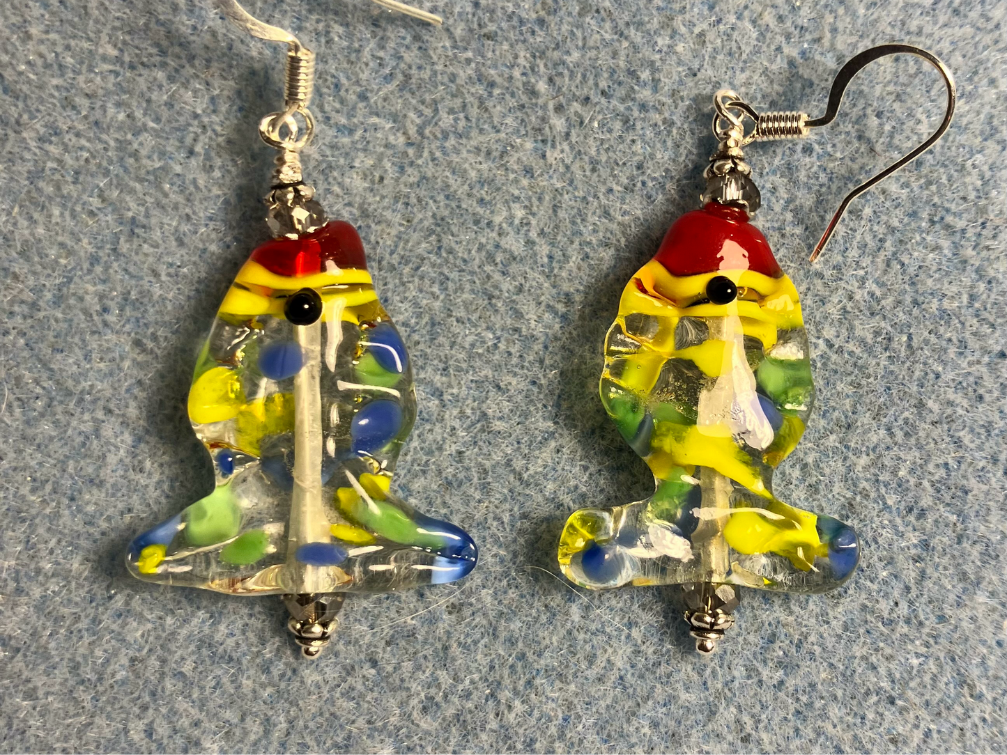 Colorful yellow, red, and blue lamp work fish bead earrings adorned with clear Chinese crystal beads.