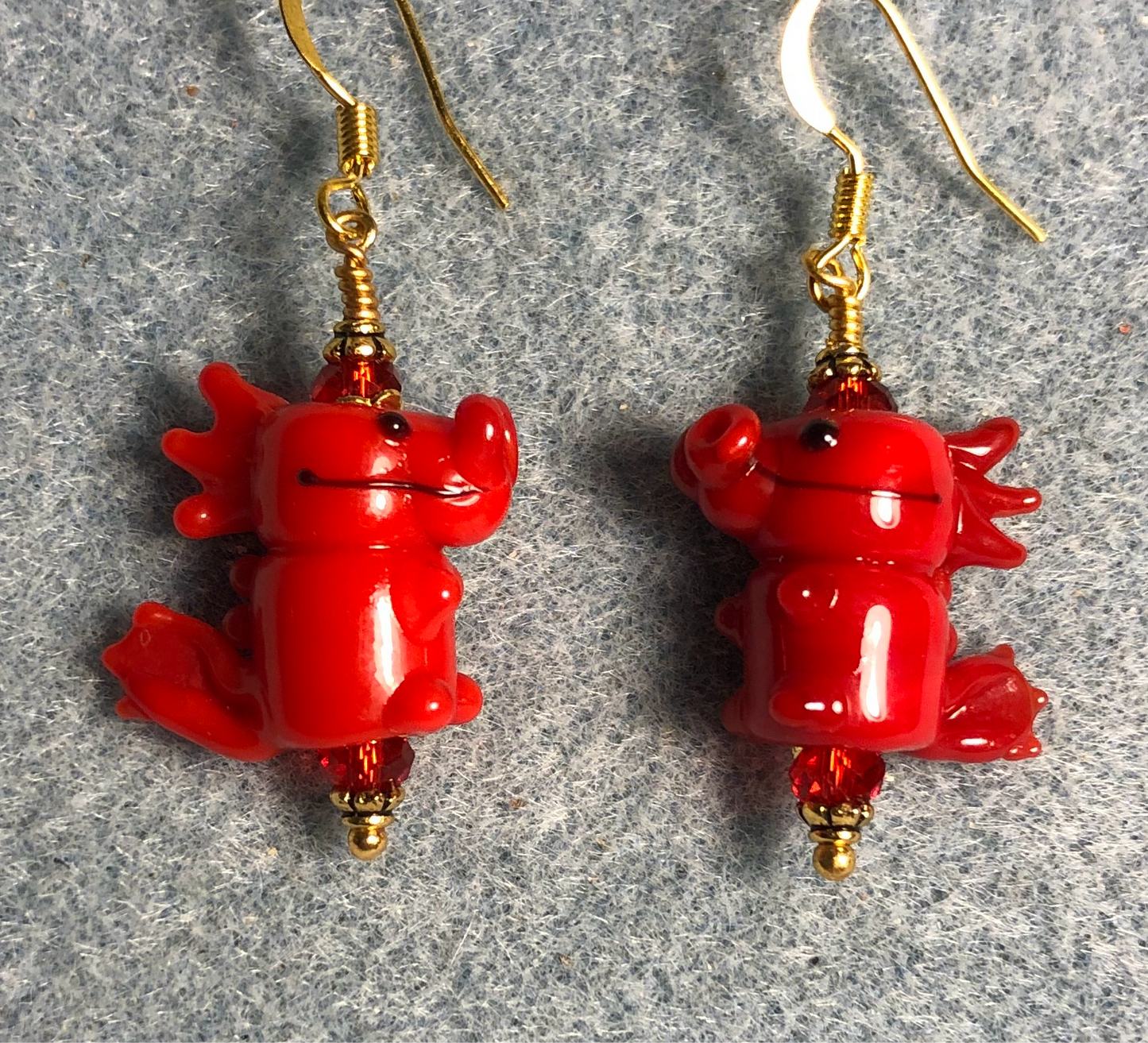 Red lamp work dragon bead earrings adorned with red Chinese crystal beads.