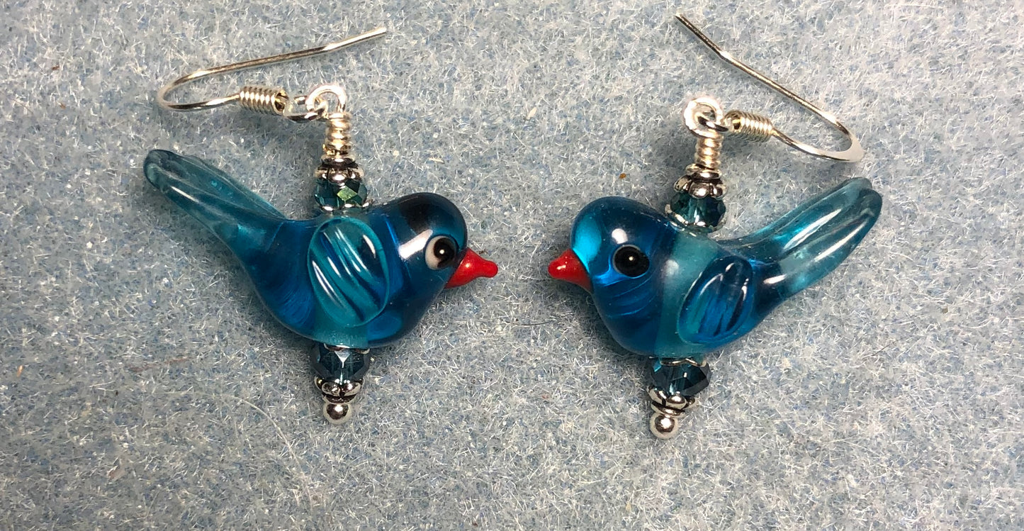 Translucent turquoise lamp work songbird bead earrings adorned with turquoise Chinese crystal beads.