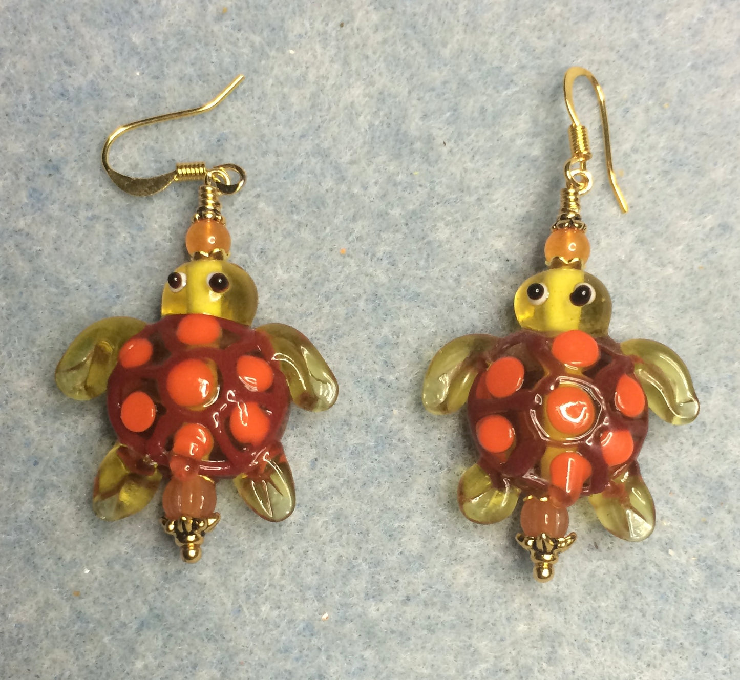 Yellow and orange lamp work spotted turtle bead earrings adorned with orange Czech glass beads.