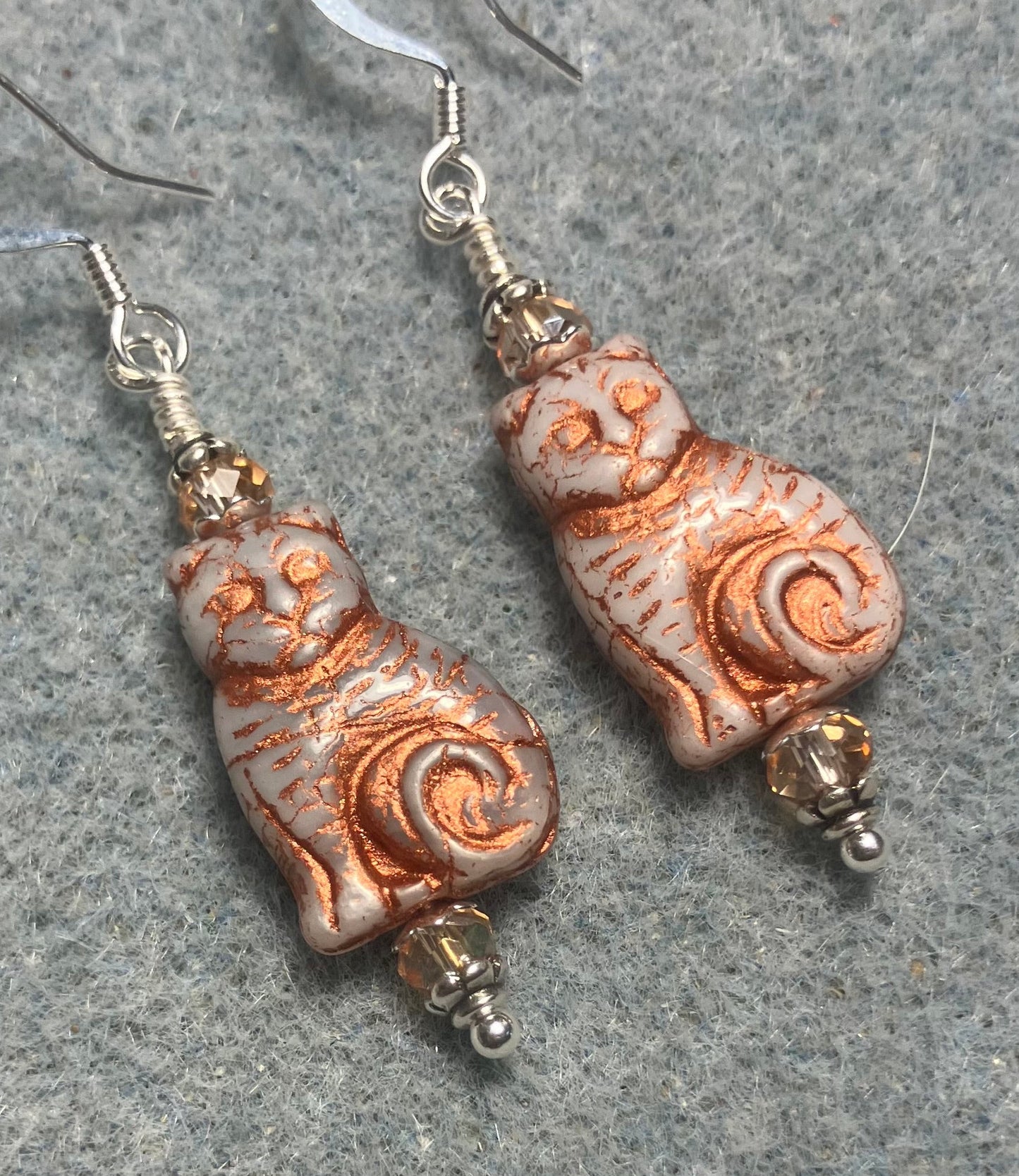 Medium beige (with copper inlay) Czech glass cat bead earrings adorned with peach copper Chinese crystal beads.