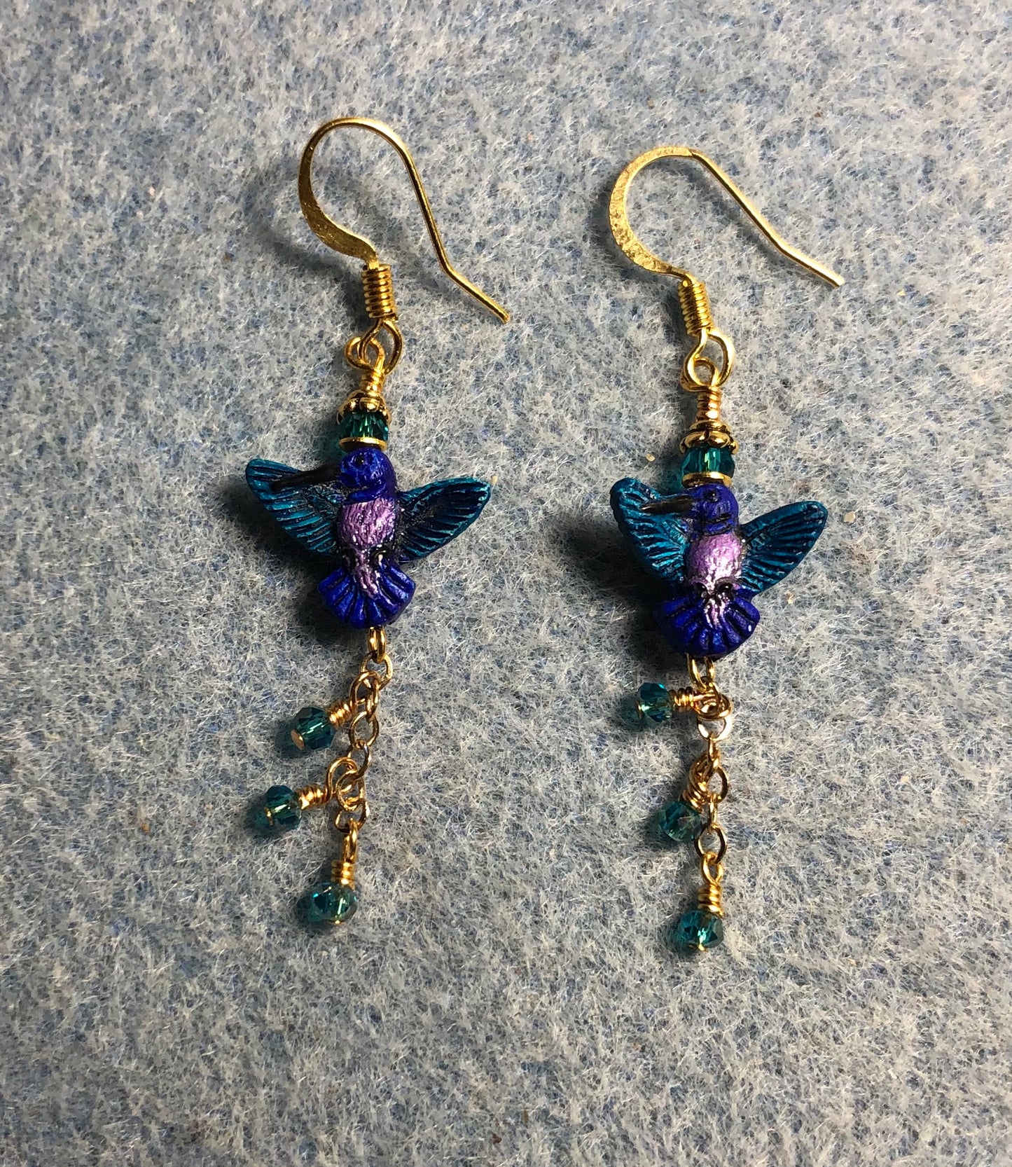 Small turquoise and purple hummingbird bead earrings adorned with gold chain and tiny turquoise Chinese crystal beads.