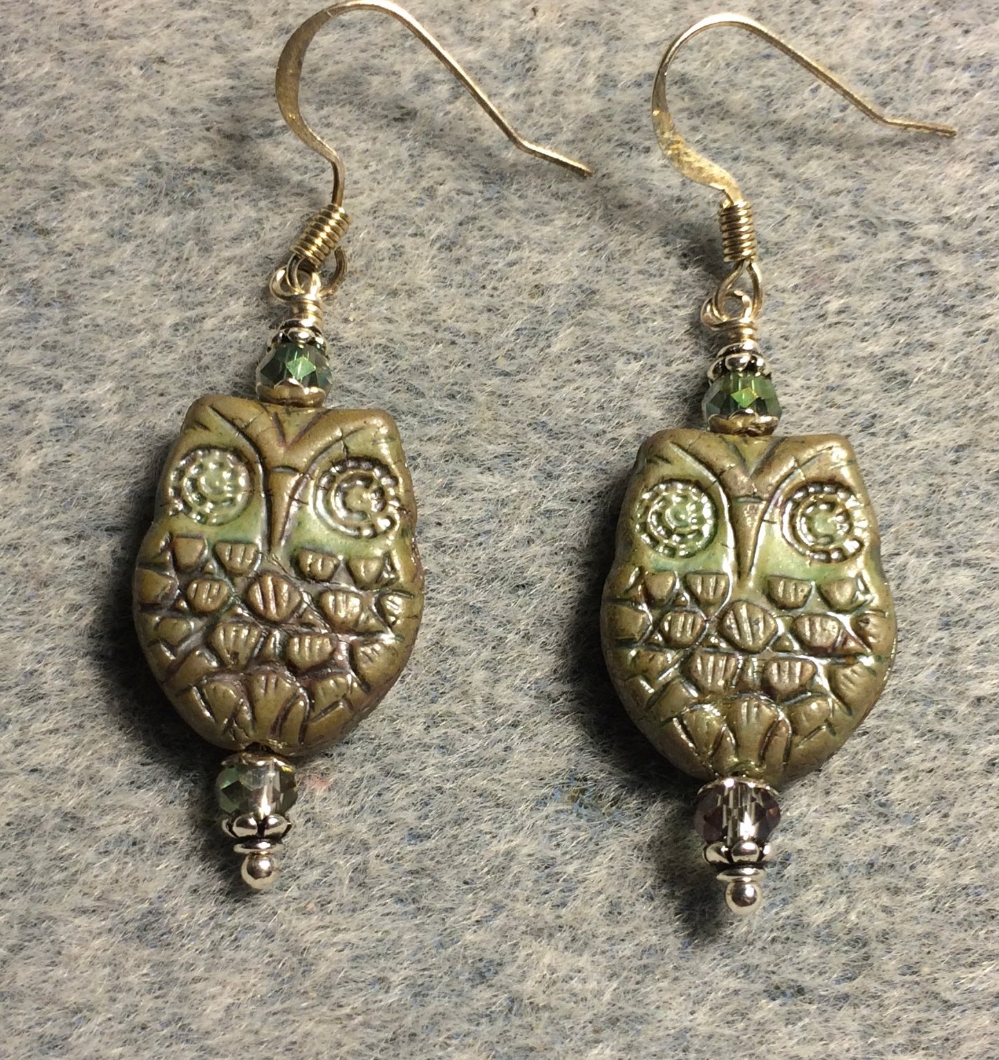 Brownish green Czech glass owl bead earrings adorned with iridescent green Chinese crystal beads.