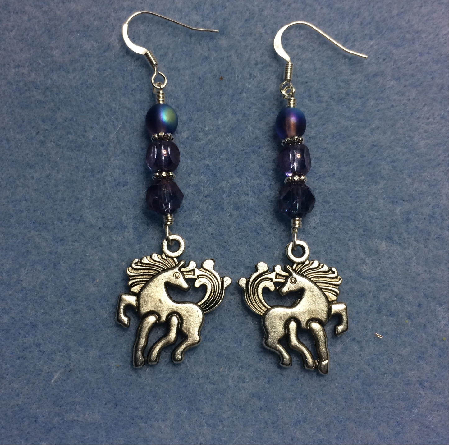 Silver unicorn charm earrings adorned with purple Czech glass beads