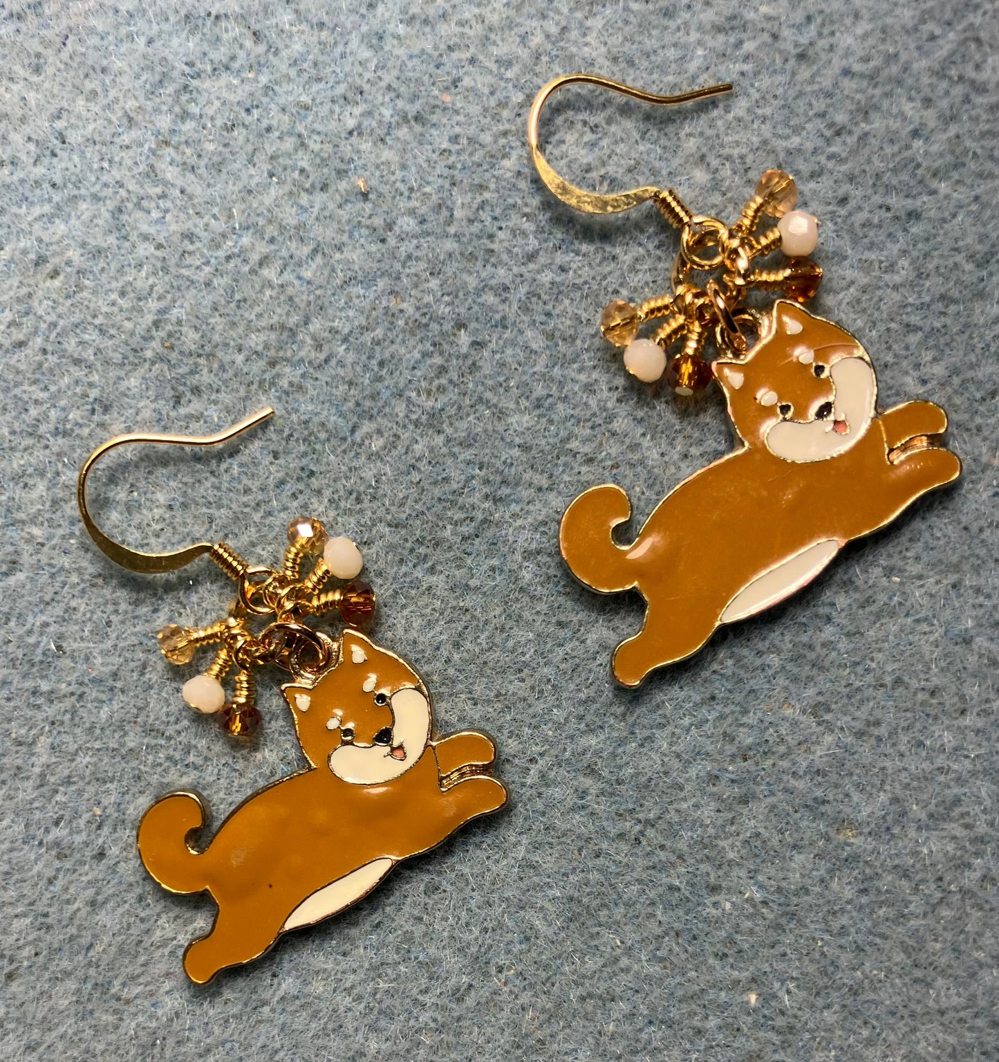 Brown and white enamel Shiba Inu charm earrings adorned with tiny dangling brown, white, and amber Chinese crystal beads.